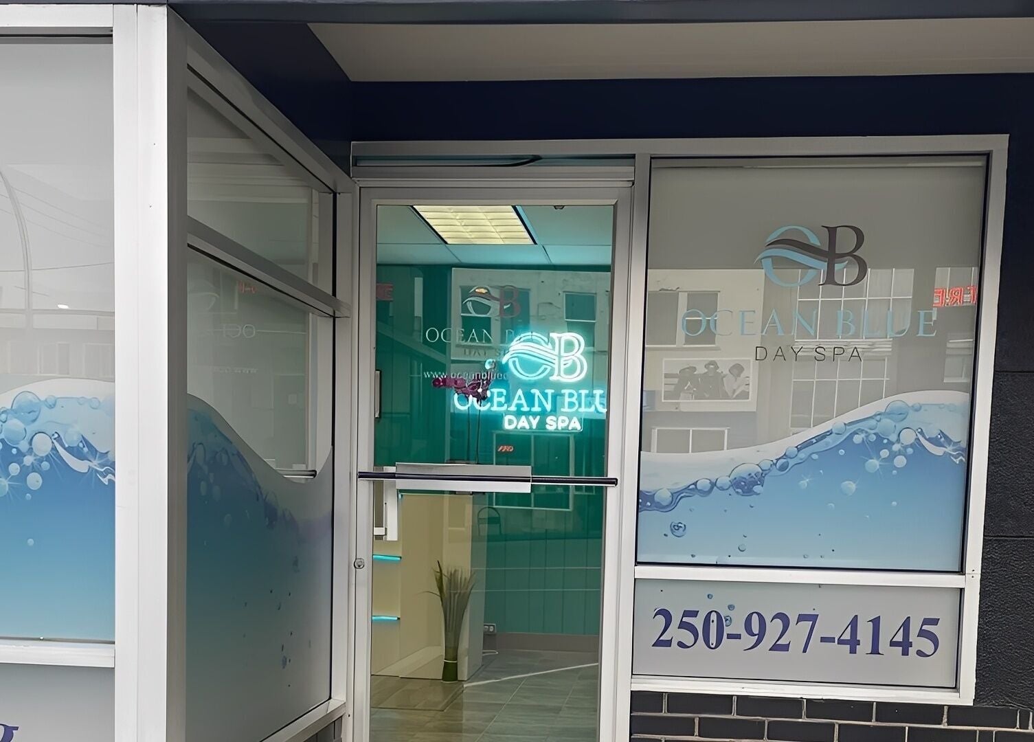Entrance of Ocean Blue Day Spa in Port Alberni, British Columbia, CA, showcasing elegant glass design.