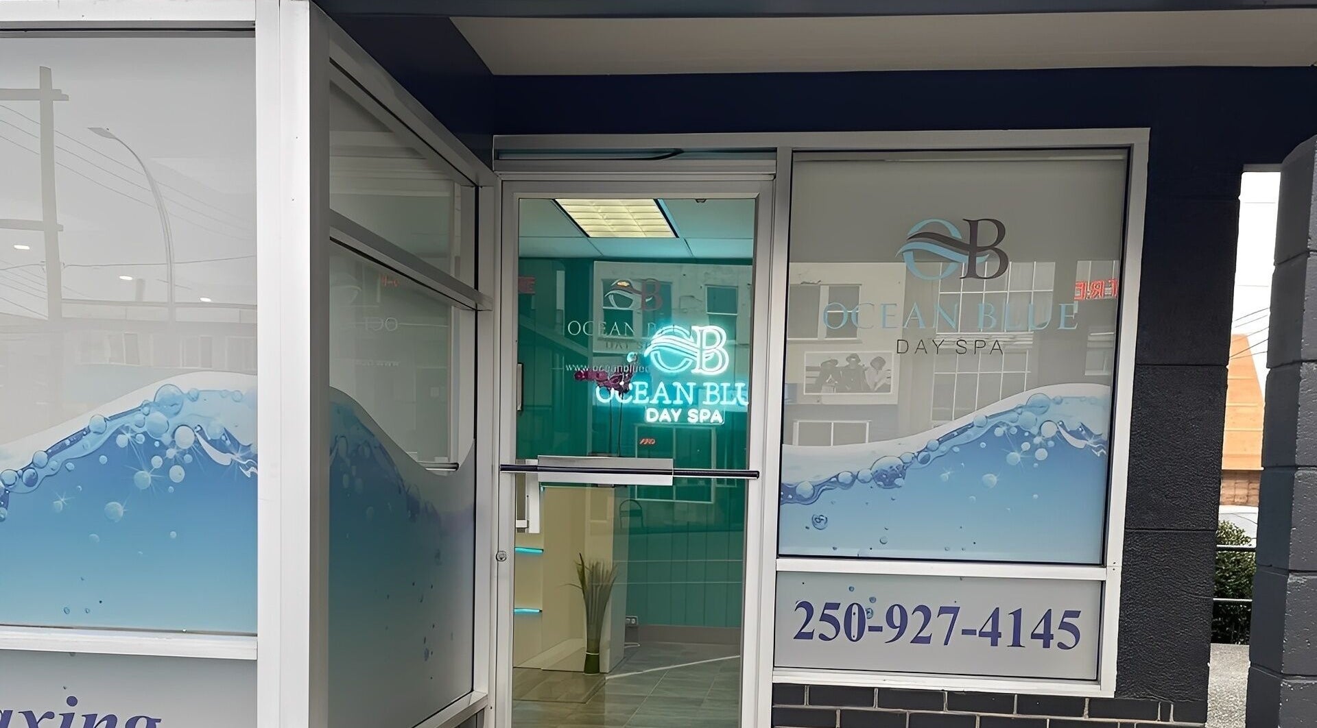 Entrance of Ocean Blue Day Spa in Port Alberni, British Columbia, CA, showcasing elegant glass design.