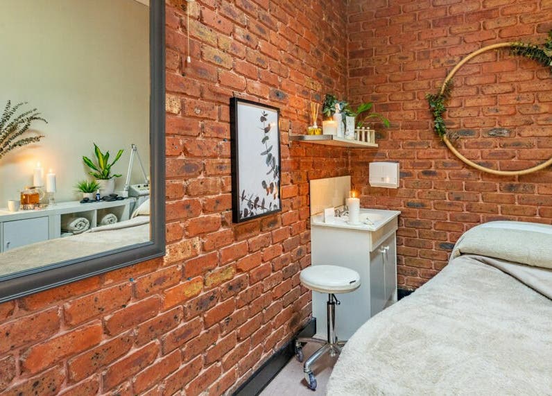 Cozy spa room with brick walls at Nature's Beauty Secrets, Melbourne, Victoria, AU, featuring earthy decor.