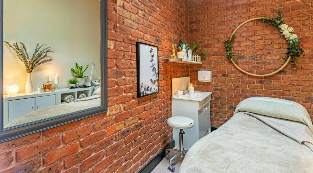 Cozy spa room with brick walls at Nature's Beauty Secrets, Melbourne, Victoria, AU, featuring earthy decor.