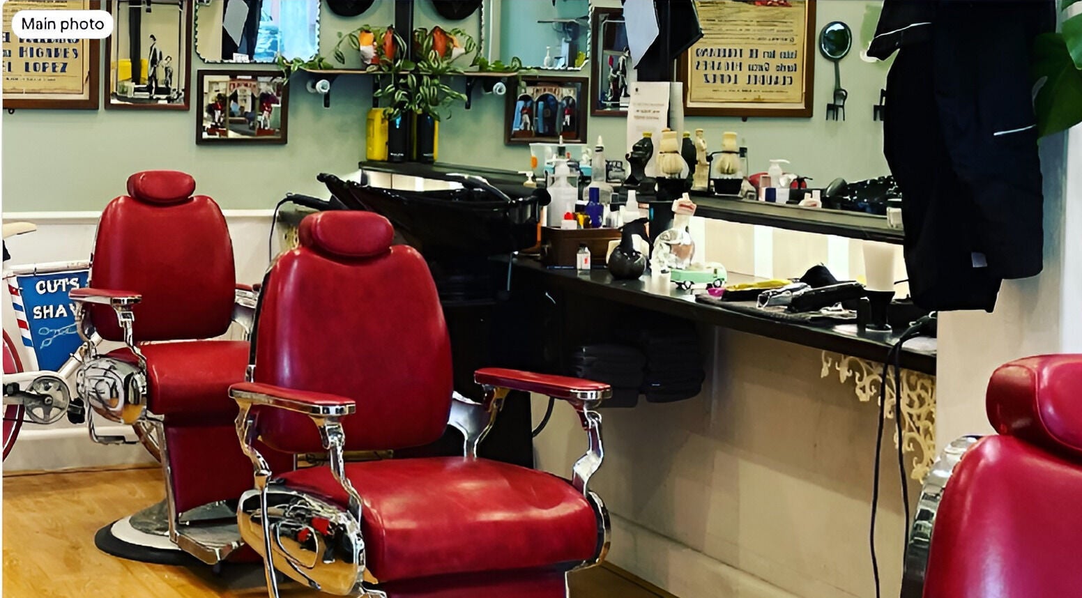 Classic red chairs at Le Barbier d’ Elwood, Melbourne, Victoria, AU, showcasing stylish barber ambiance.