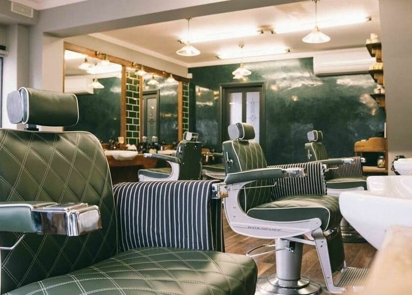 Interior of Robert Williams Barbershop, Southend-on-Sea, featuring stylish chairs and mirrors.