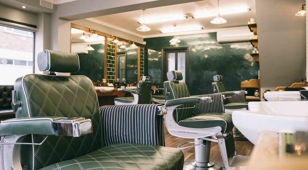 Interior of Robert Williams Barbershop, Southend-on-Sea, featuring stylish chairs and mirrors.