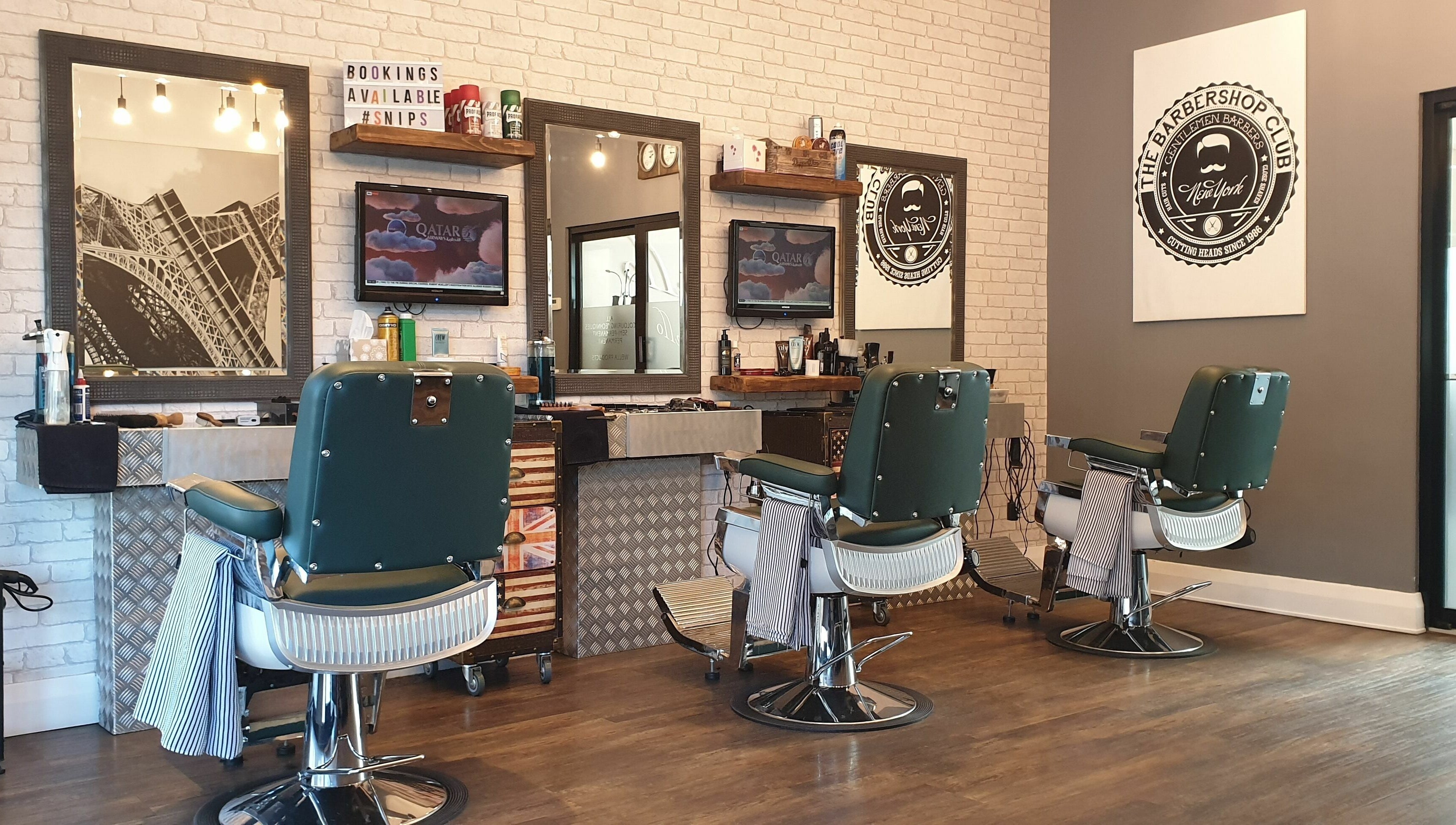 Chic interior of Mr Snips Heswall, a modern barbershop in Heswall, England, GB, featuring classic chairs and decor.