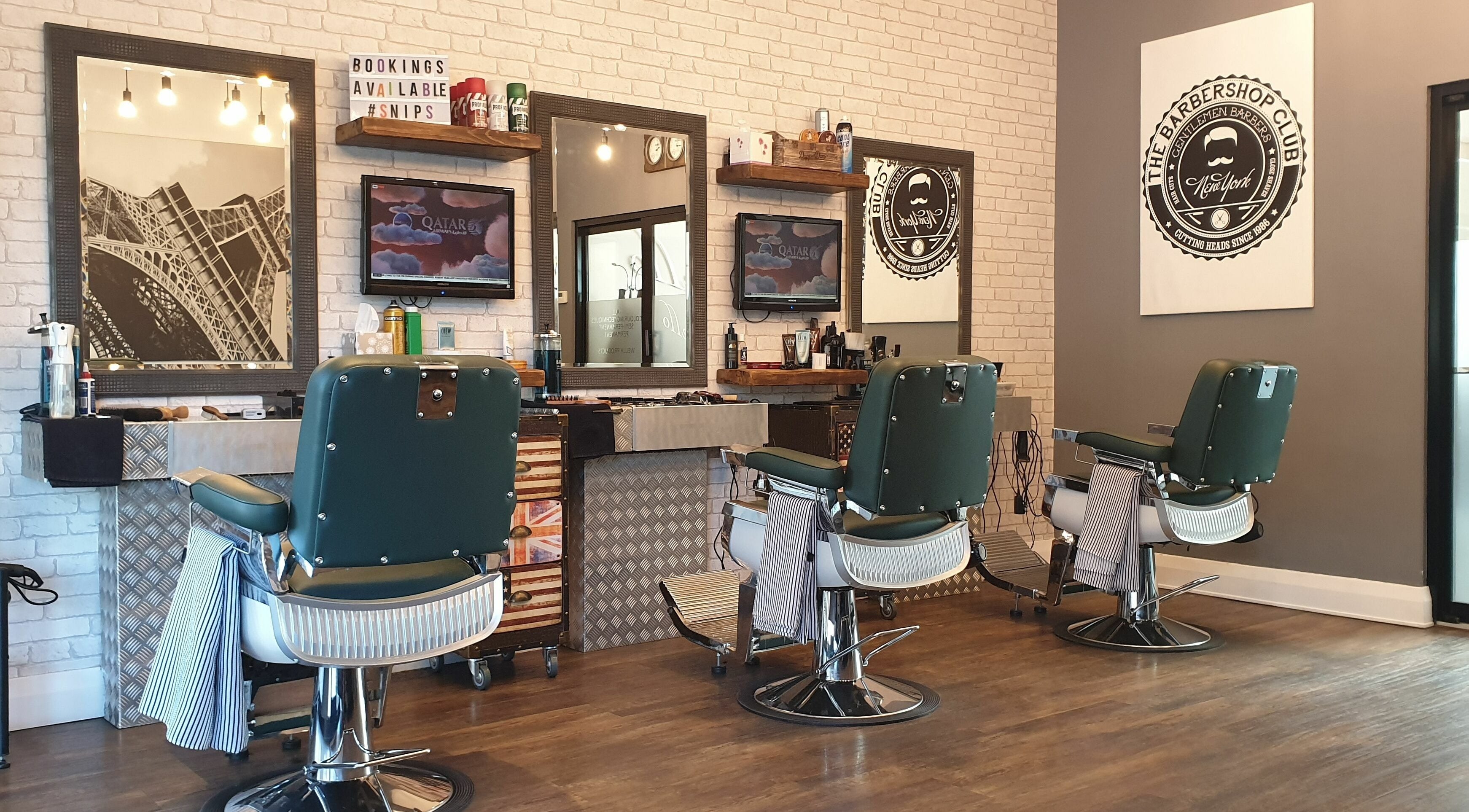 Chic interior of Mr Snips Heswall, a modern barbershop in Heswall, England, GB, featuring classic chairs and decor.
