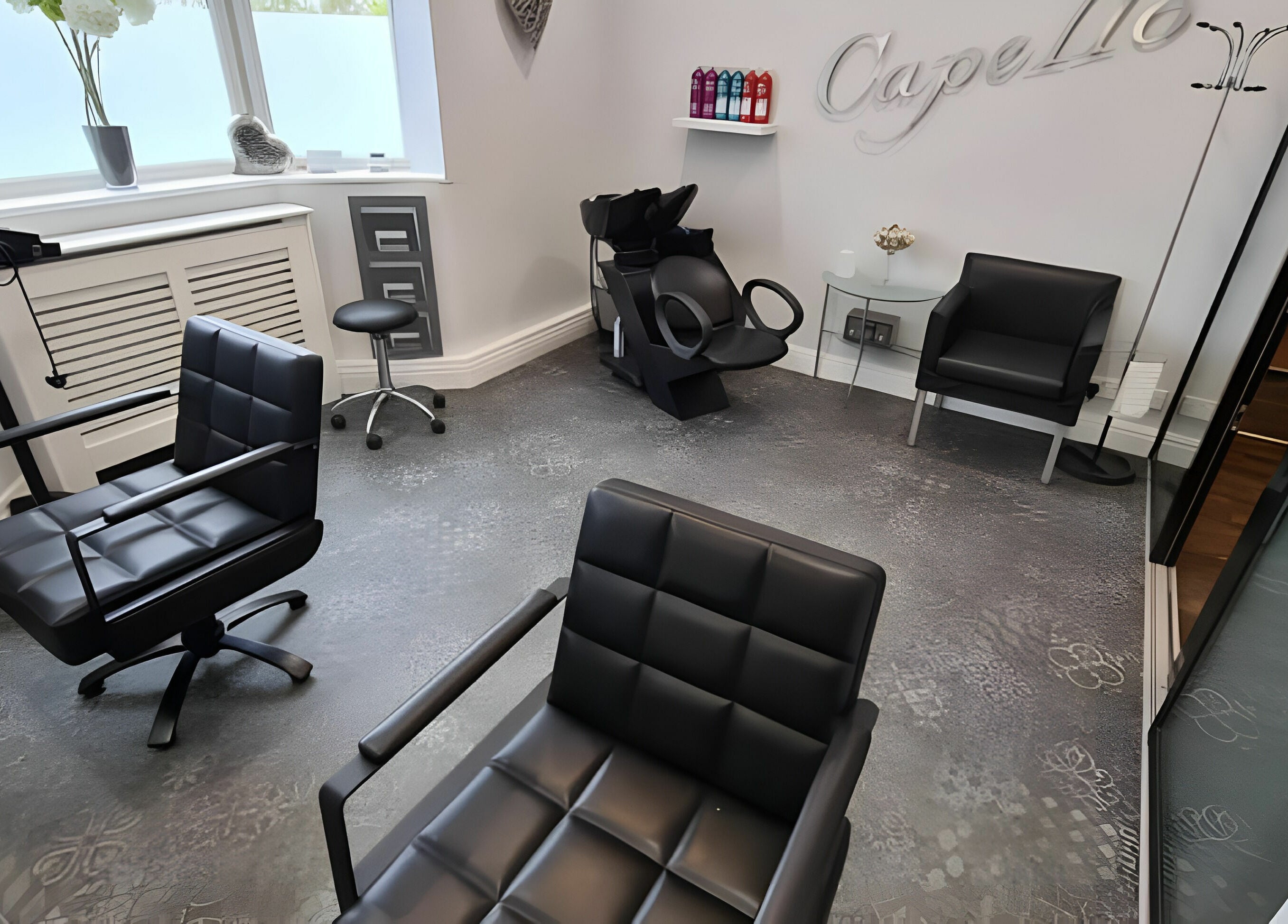 Chic interior of Mr Snips Heswall salon, featuring modern styling chairs in Heswall, England, GB.