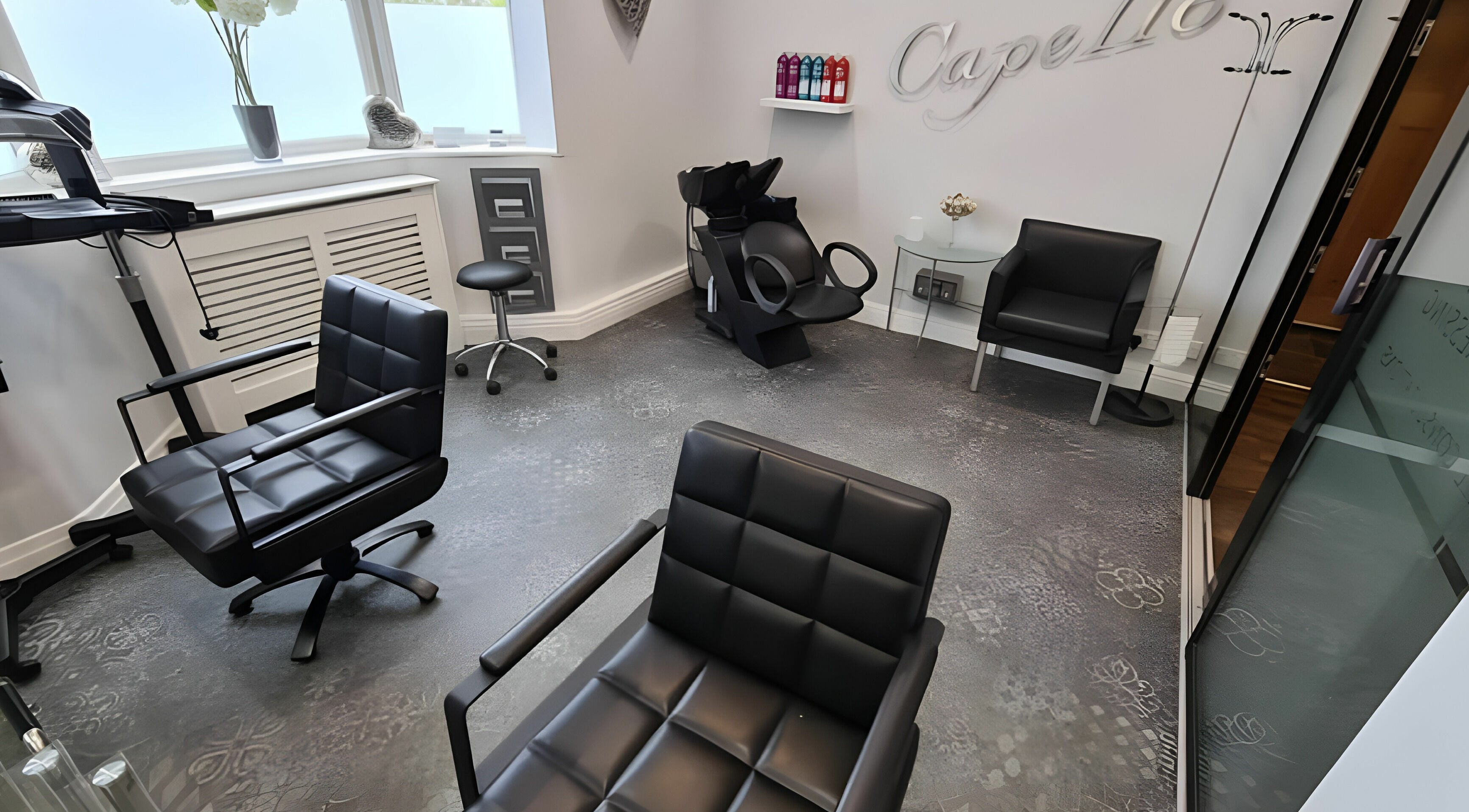 Chic interior of Mr Snips Heswall salon, featuring modern styling chairs in Heswall, England, GB.