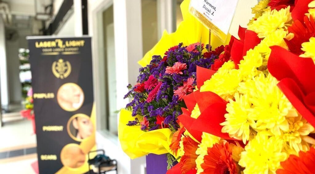 Bright floral arrangement at Laser Light Skin Centre Shah Alam, Selangor, MY, with elegant signage in view.