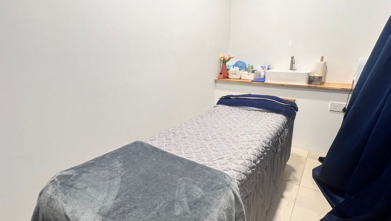 Serene treatment room at Laser Light Skin Centre Johor Bahru, Johor Bahru, Johor, MY with plush table and decor.