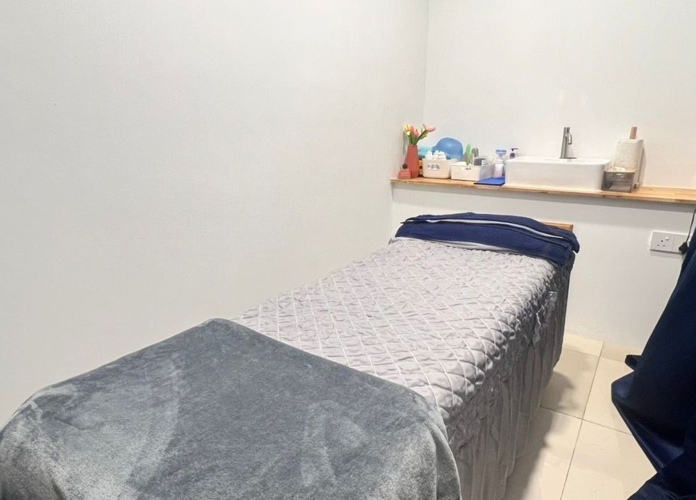 Serene treatment room at Laser Light Skin Centre Johor Bahru, Johor Bahru, Johor, MY with plush table and decor.