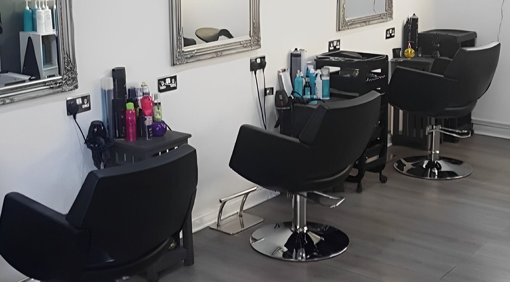 Elegant salon chairs at Marie Walker Hair, Armadale, Scotland, GB, showcasing a modern styling area.