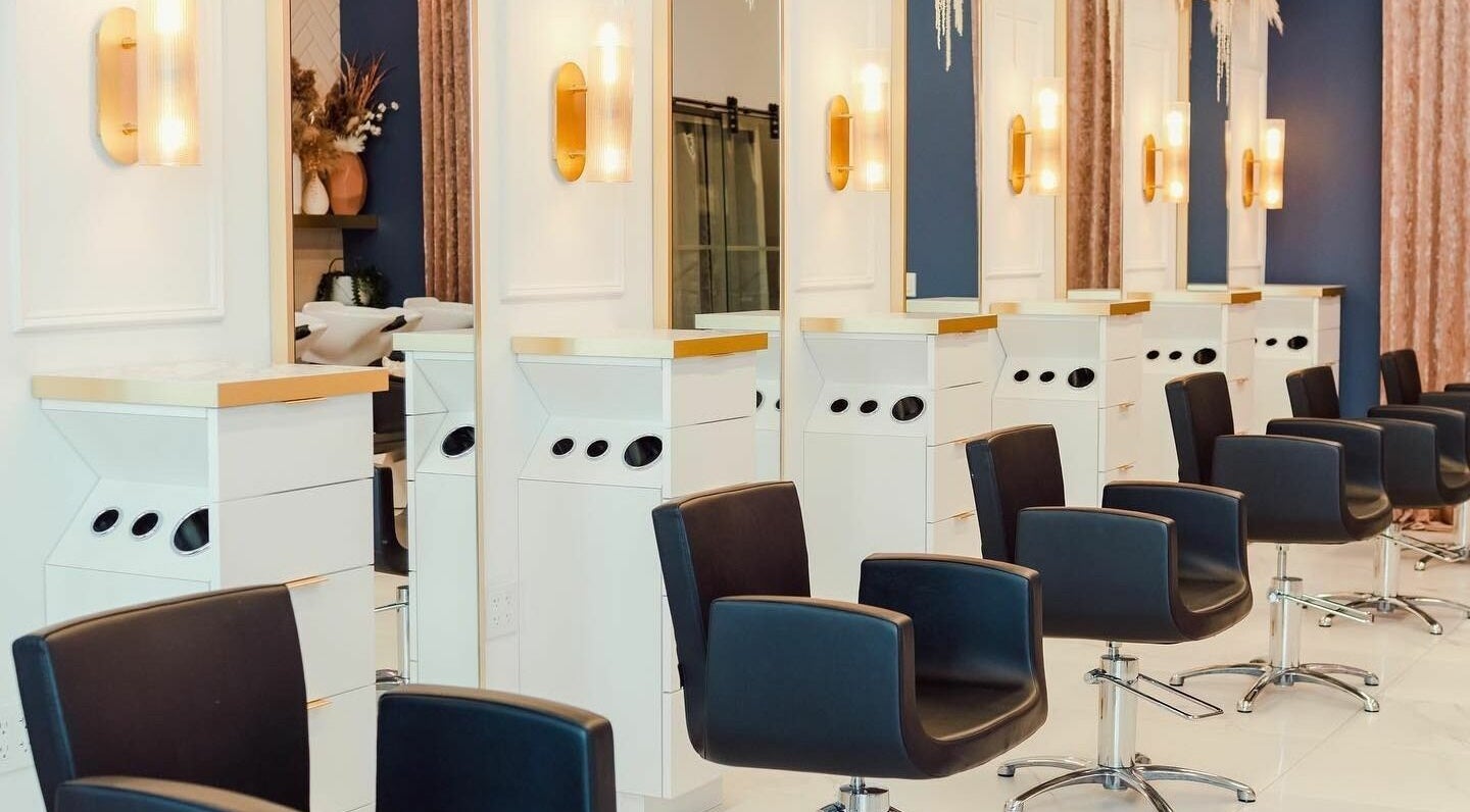Modern salon chairs and stations at Her Studios Inc., Burlington, Ontario, CA offering luxury styling experiences.