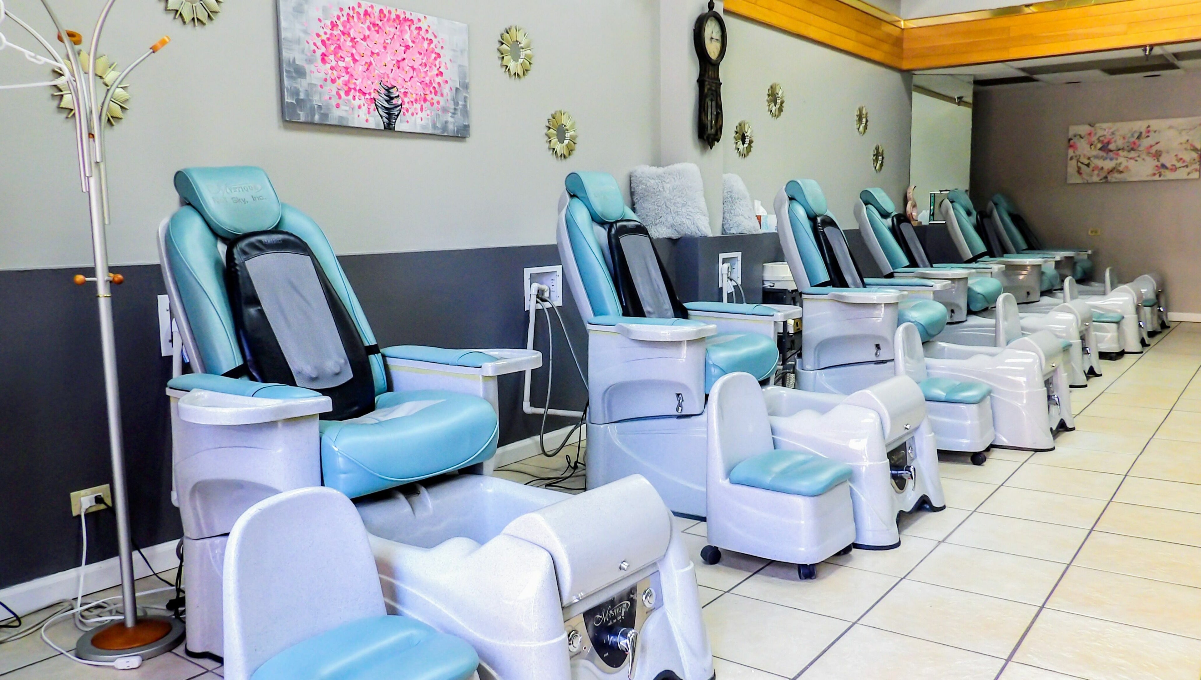 Rows of pedicure chairs at Flawless Nail Bar, Denver, Colorado, US, showcasing a serene environment.