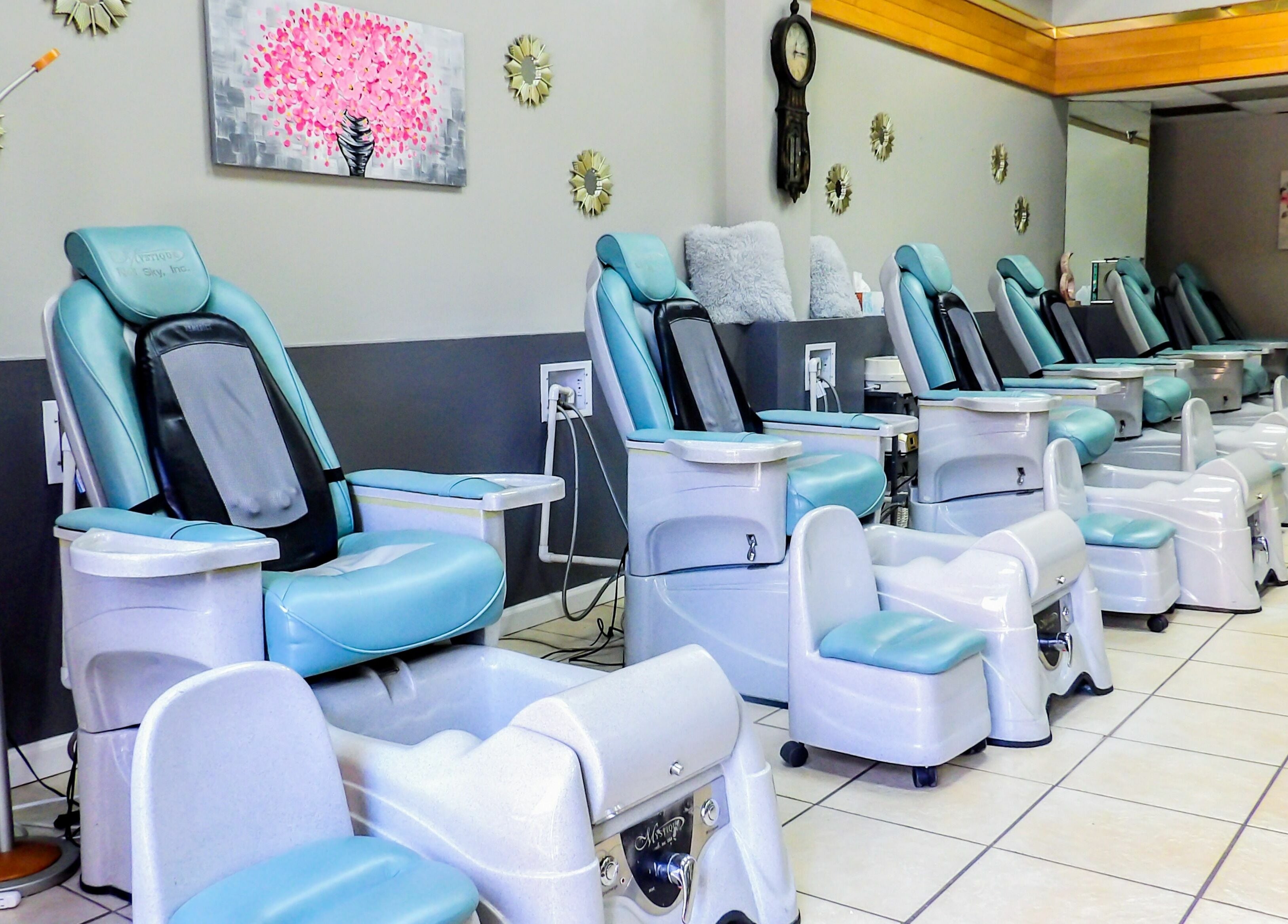 Rows of pedicure chairs at Flawless Nail Bar, Denver, Colorado, US, showcasing a serene environment.