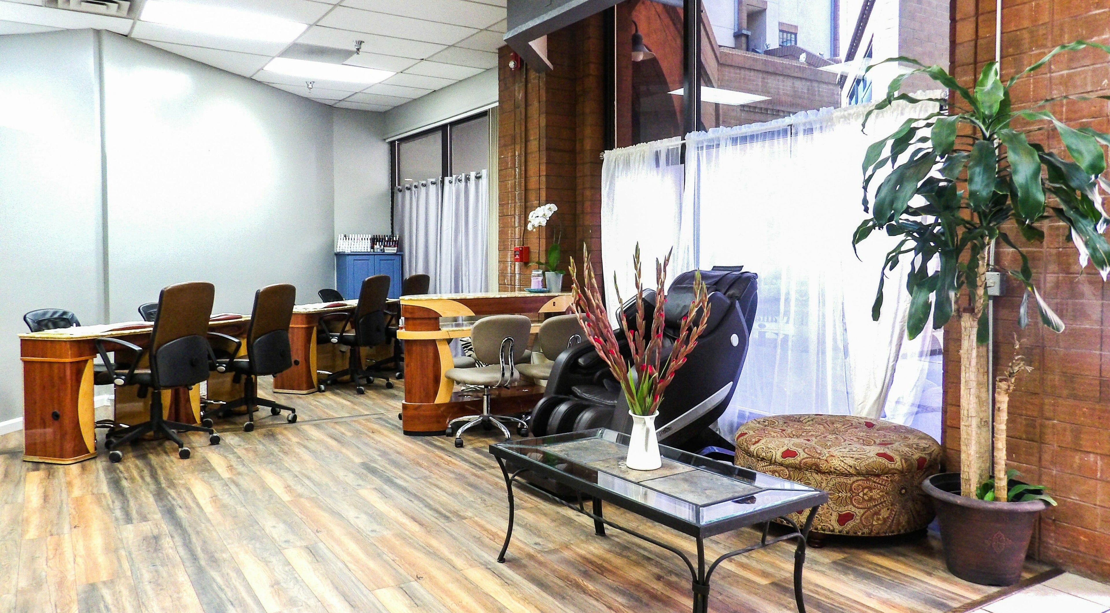 Modern interior of Flawless Nail Bar in Denver, Colorado, US featuring cozy seating and natural decor.
