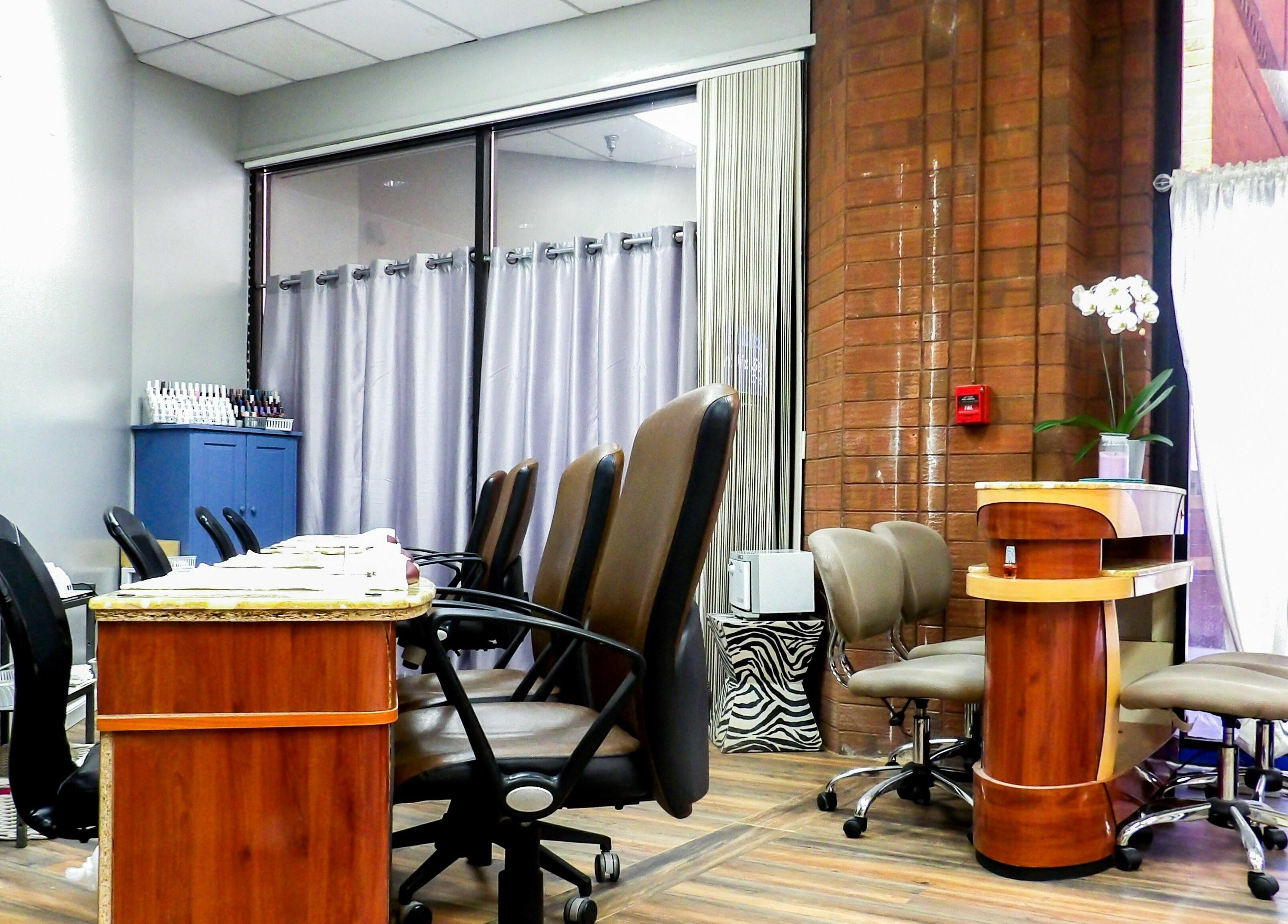 Interior view of Flawless Nail Bar, Denver, Colorado, US, showcasing modern manicure stations and decor.