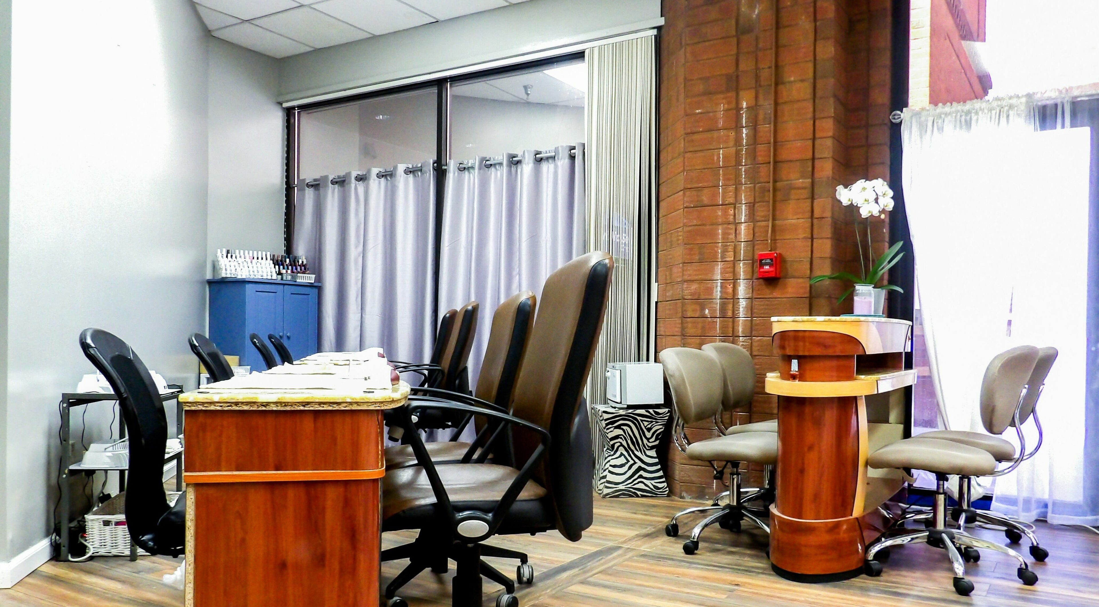 Interior view of Flawless Nail Bar, Denver, Colorado, US, showcasing modern manicure stations and decor.