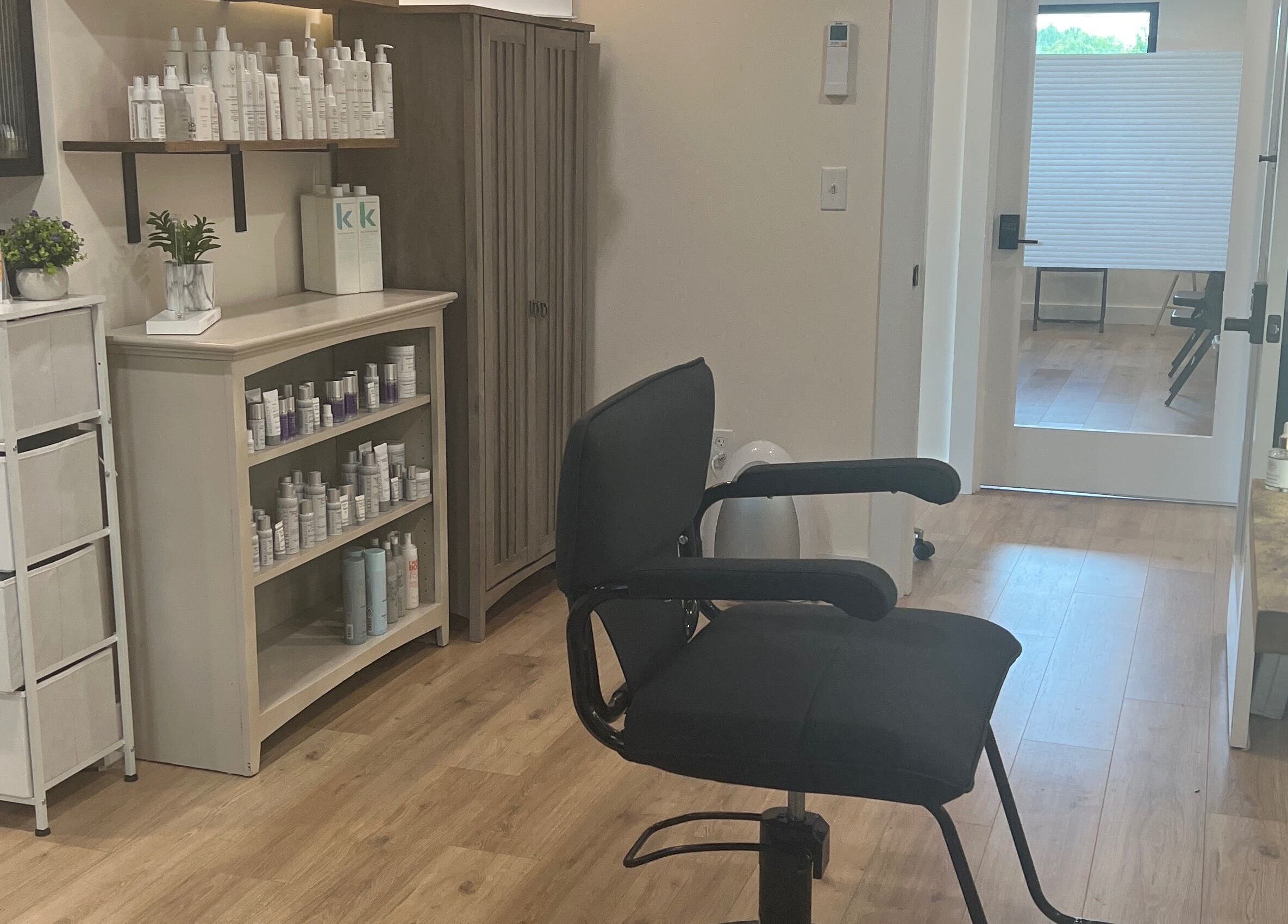 Stylish interior of 771 Beaute’ Bar in Buxton, Maine, US, featuring a salon chair and product shelves.