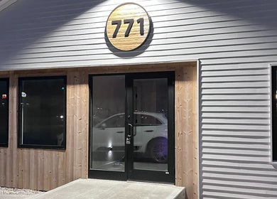 Front entrance of 771 Beaute’ Bar, Buxton, Maine, US, warmly lit exterior with visible number sign.