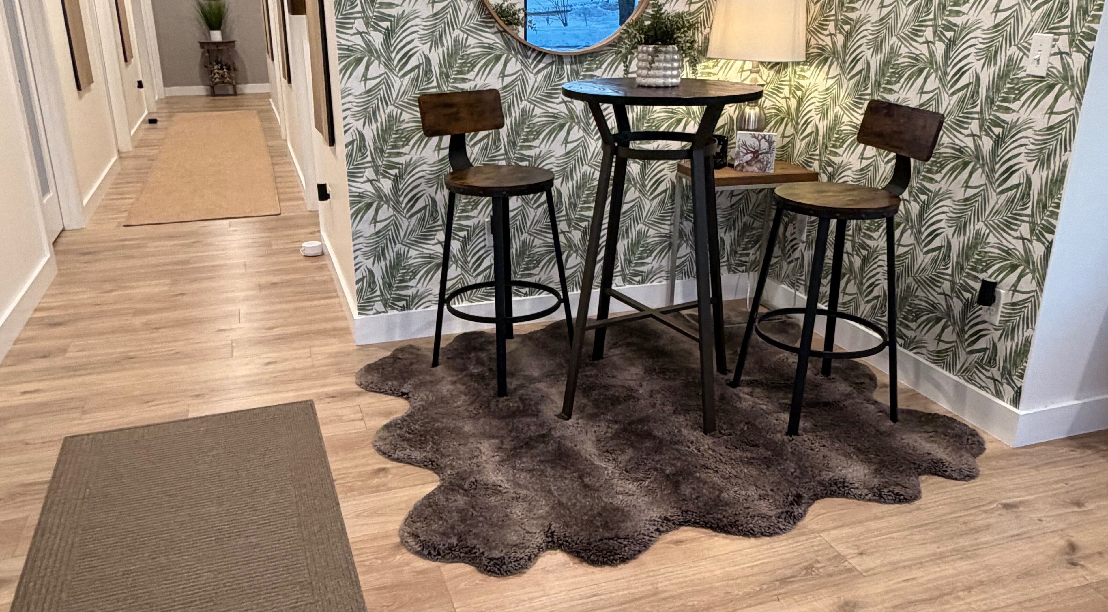 Inviting seating nook in 771 Beaute’ Bar, Buxton, Maine, US, with tropical decor and chic furnishings.