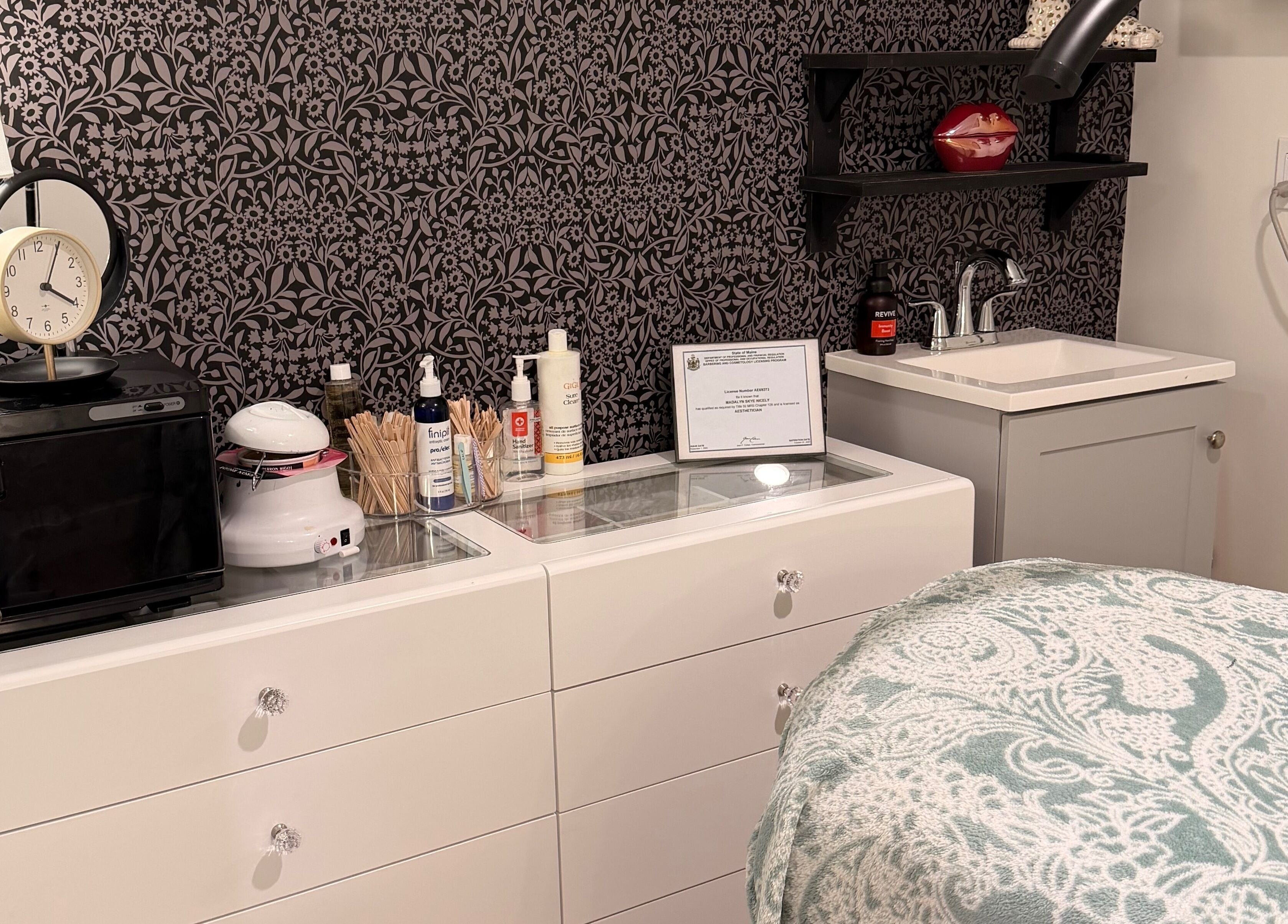 A cozy treatment room at 771 Beaute’ Bar in Buxton, Maine, US, featuring elegant decor and beauty equipment.