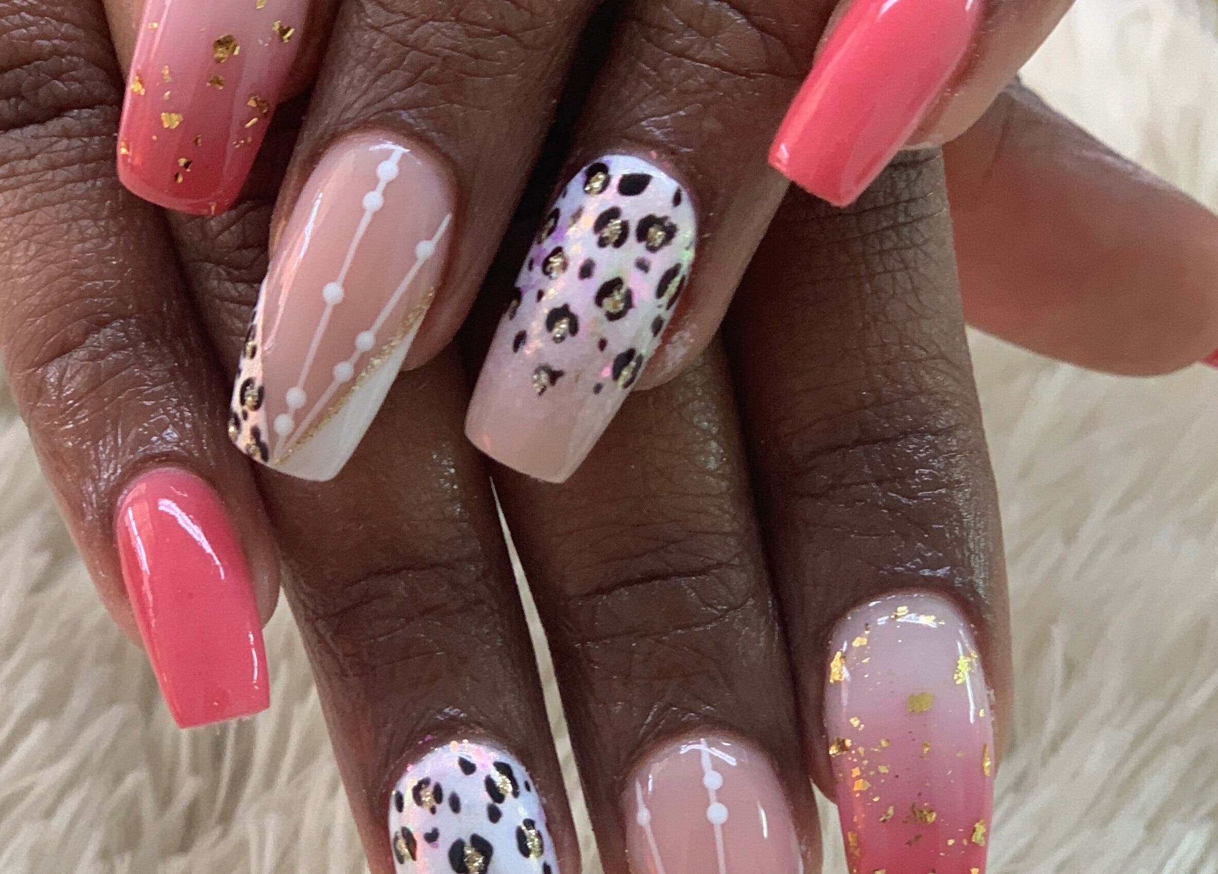 Vibrant nail art with pink and animal patterns at Blushed On! Nails&Beauty Verulam, Verulam, KwaZulu-Natal, ZA.