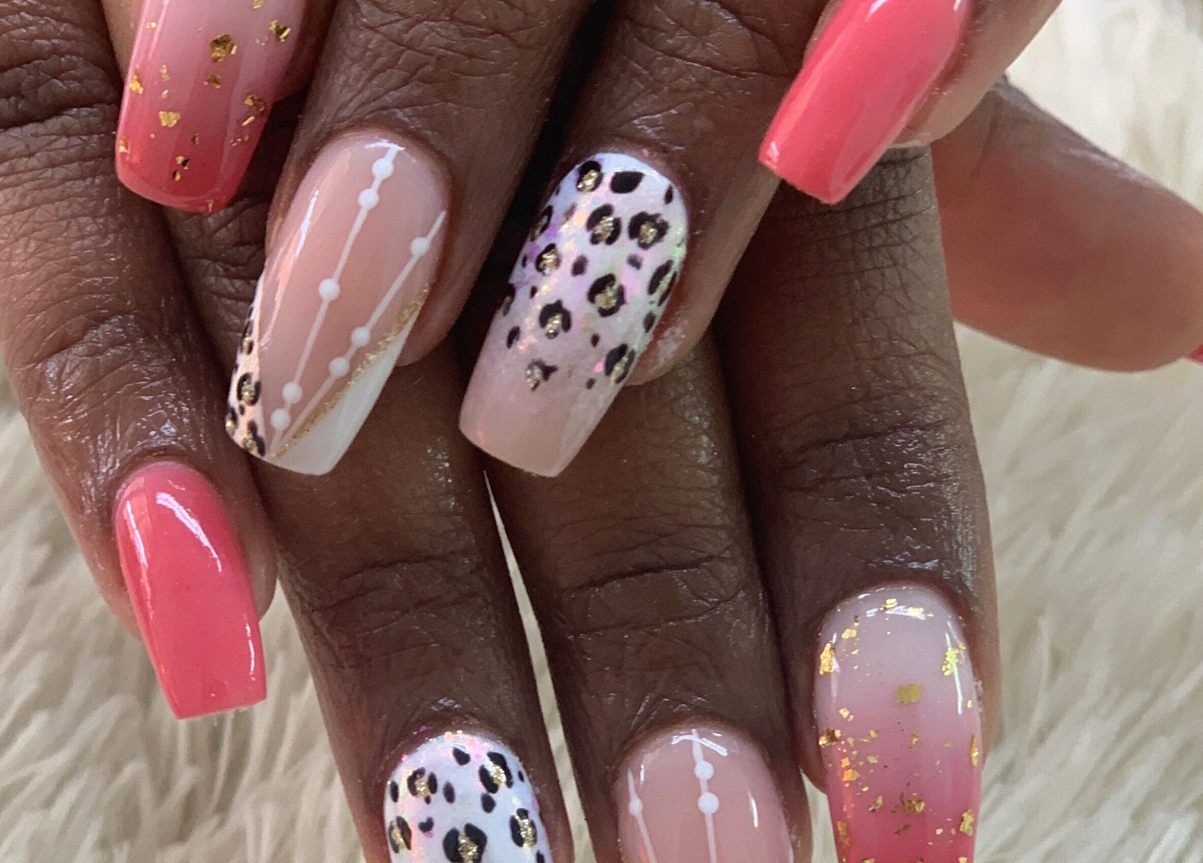 Vibrant nail art with pink and animal patterns at Blushed On! Nails&Beauty Verulam, Verulam, KwaZulu-Natal, ZA.