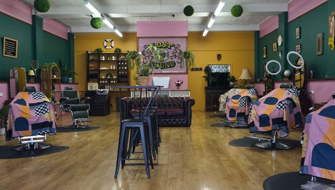 Interior of Lost N Found Barbers in Albury, New South Wales, AU with vibrant décor and barber chairs.