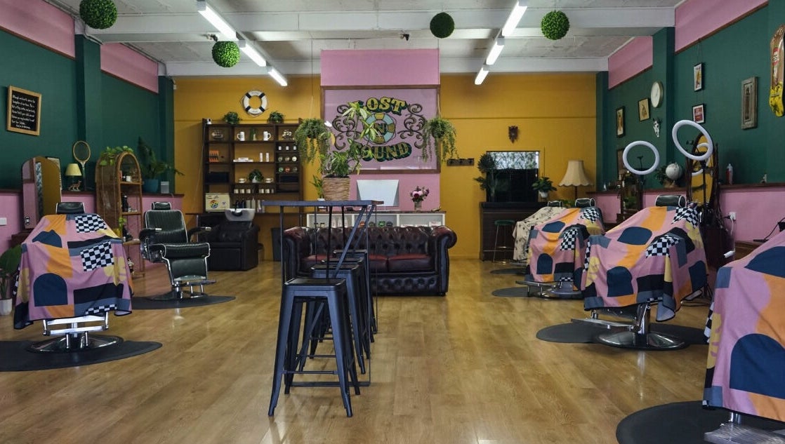 Interior of Lost N Found Barbers in Albury, New South Wales, AU with vibrant décor and barber chairs.
