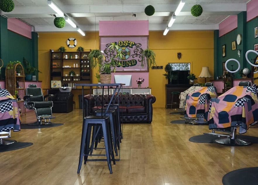 Interior of Lost N Found Barbers in Albury, New South Wales, AU with vibrant décor and barber chairs.