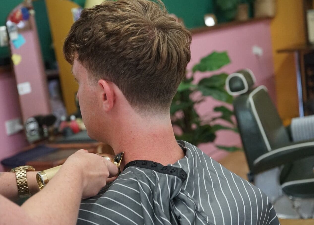 A precise haircut in progress at Lost N Found Barbers, Albury, New South Wales, AU. Stylish interior in view.