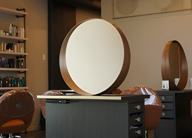 Elegant salon setup with round mirrors at Studio29 in Edmonton, Alberta, CA.