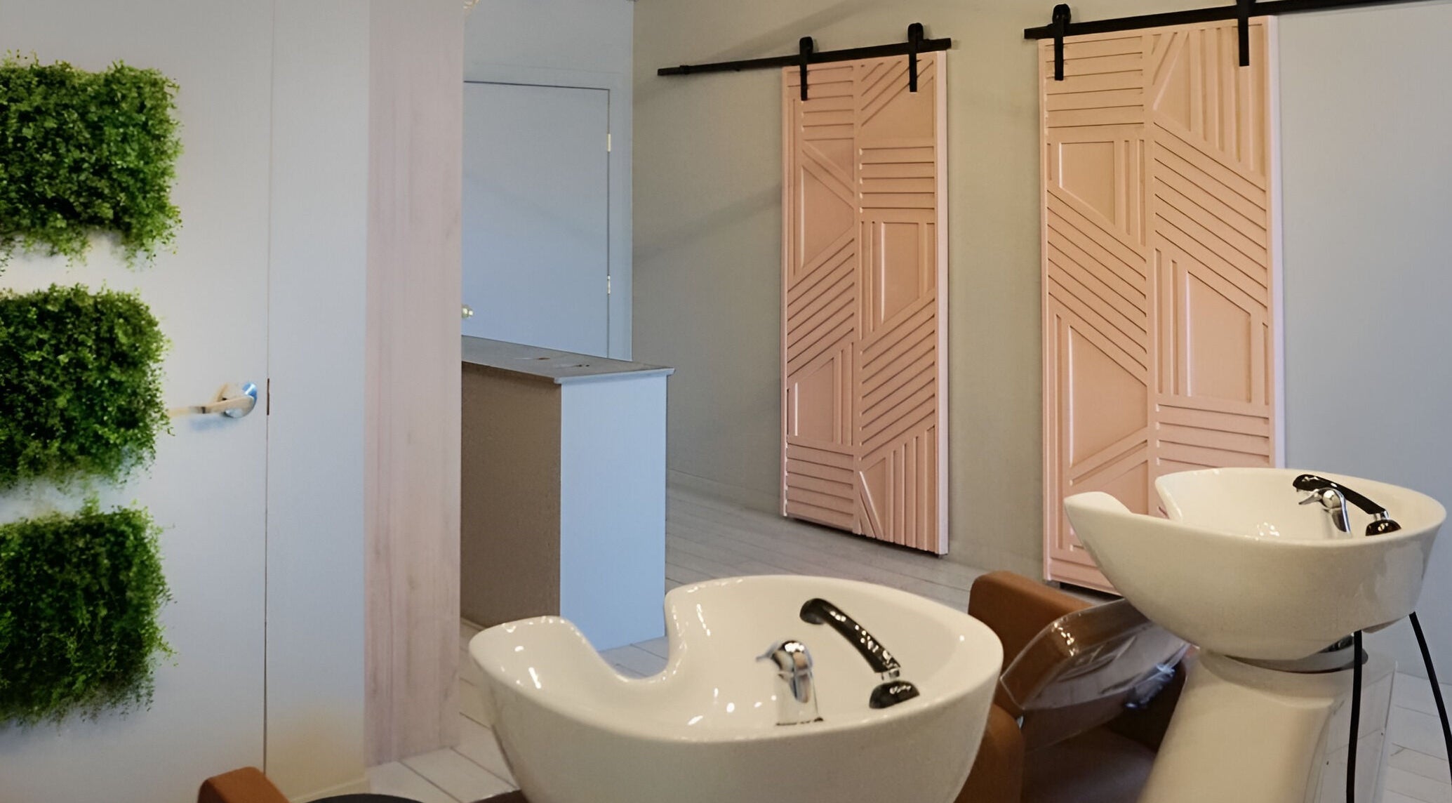 Stylish salon interior with pink doors and green decor at Studio29, Edmonton, Alberta, CA.