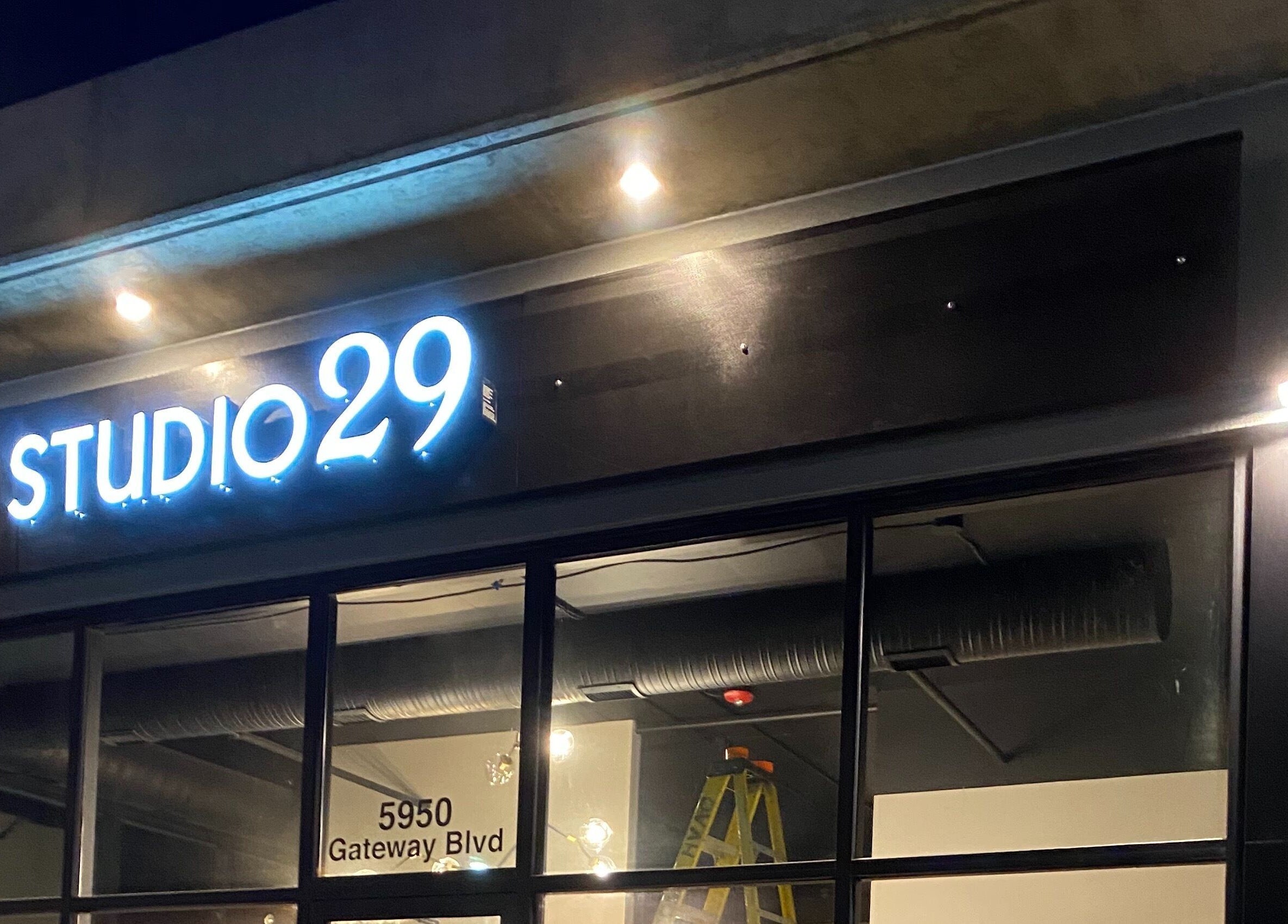 Studio29 entrance sign at night in Edmonton, Alberta, CA, glowing brightly.