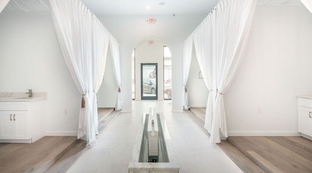 Elegant interior view of Merum Face Bar, Allen, Texas, US, featuring white drapes and modern design.