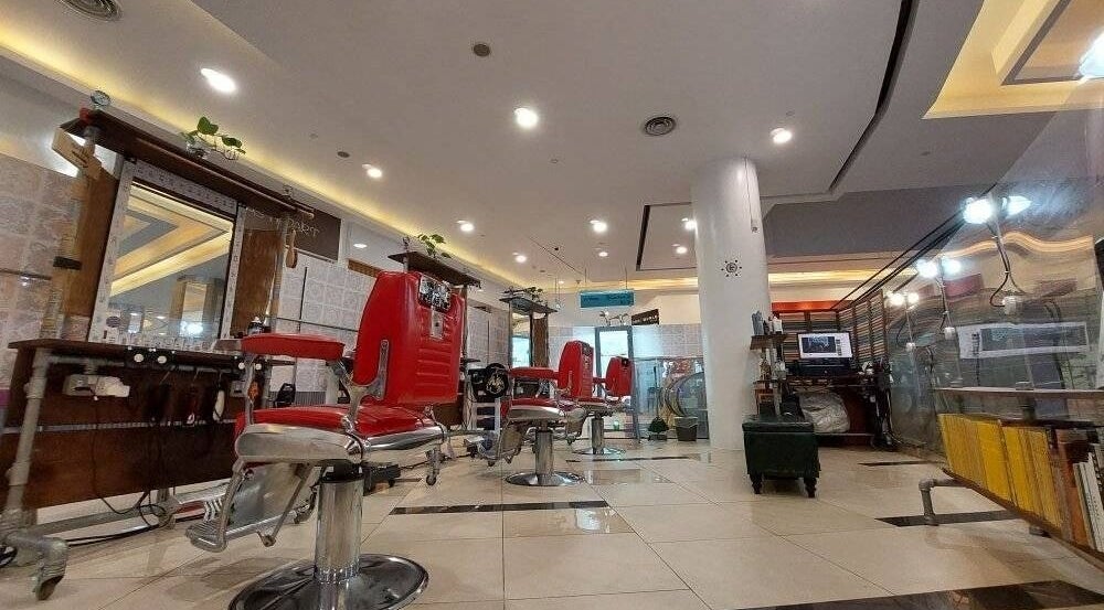 Modern interior of Rich & Ridge Hair Gallery in Singapore, SG, featuring sleek red salon chairs.