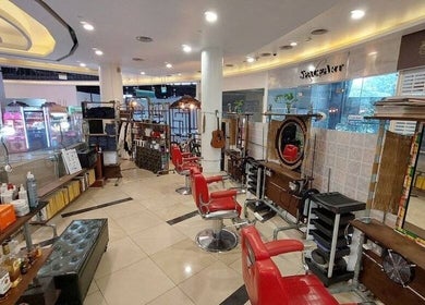 Rich & Ridge Hair Gallery in Singapore showcases stylish red chairs and elegant decor, enhancing its welcoming ambiance.