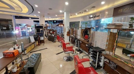 Rich & Ridge Hair Gallery in Singapore showcases stylish red chairs and elegant decor, enhancing its welcoming ambiance.