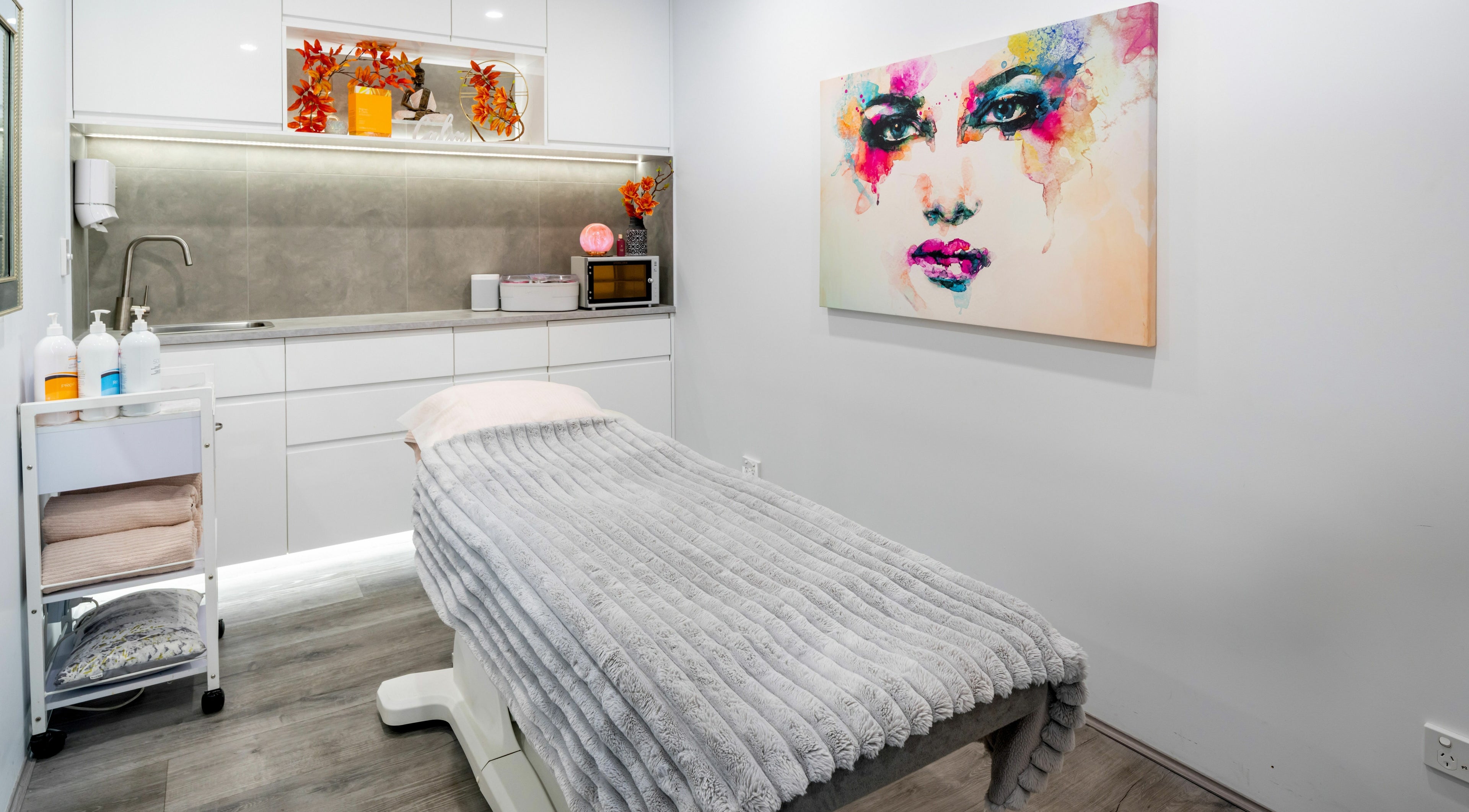 Massage room at Alana's Beauty Bliss, Hamilton Hill, WA, featuring modern decor and vibrant artwork.