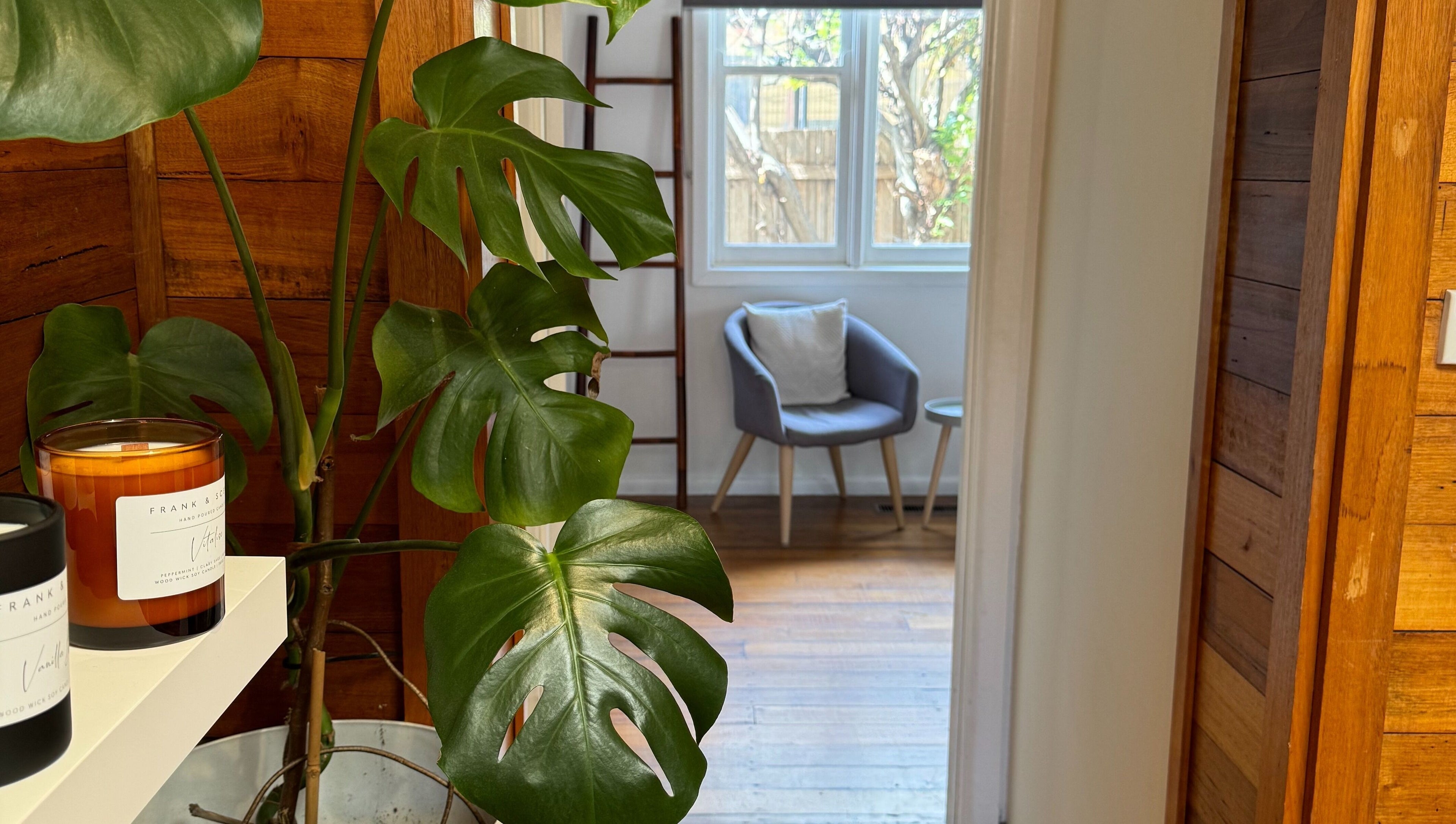 Tranquil room with plant and candles at Balanced Beauty in Melbourne, Victoria, AU.