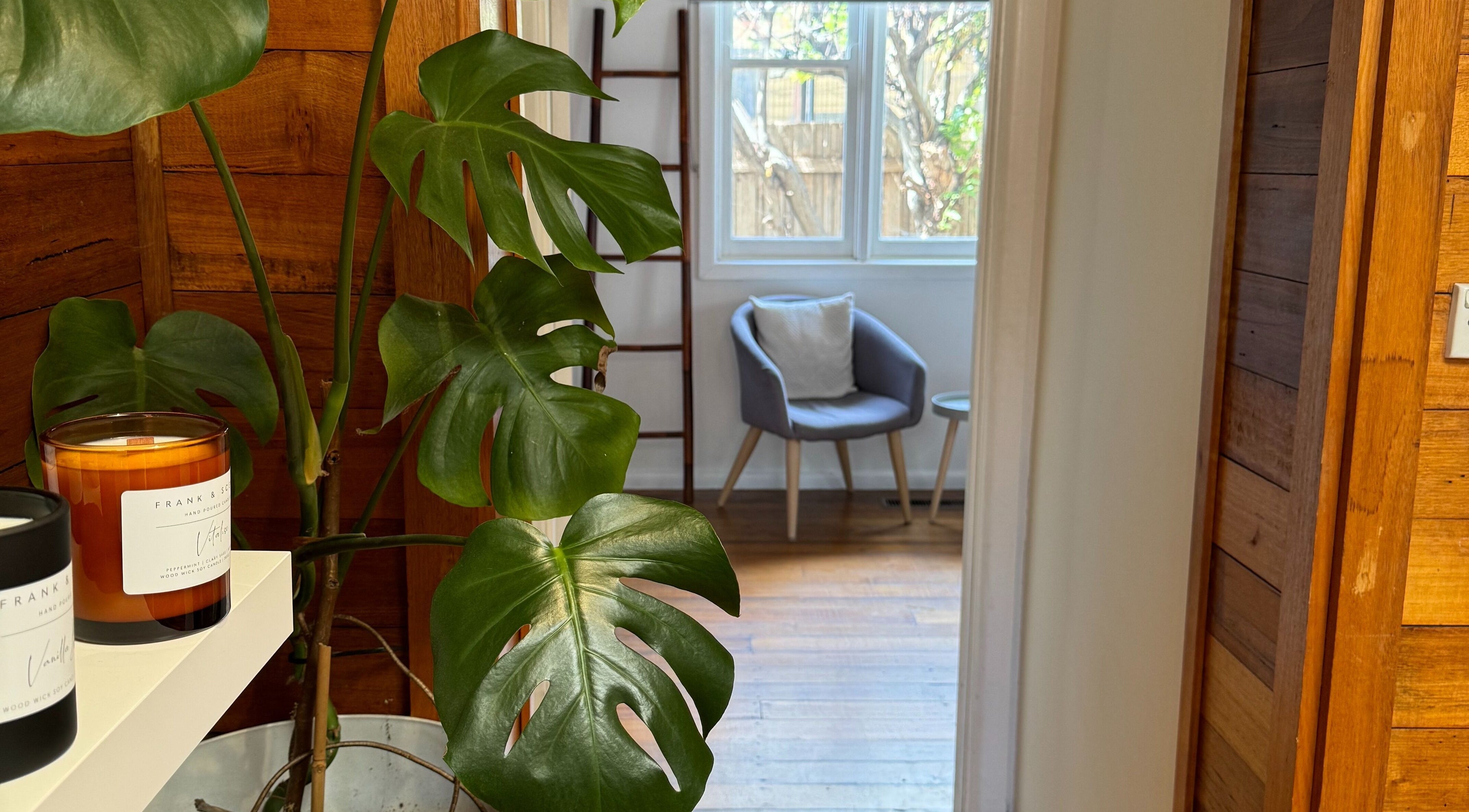 Tranquil room with plant and candles at Balanced Beauty in Melbourne, Victoria, AU.