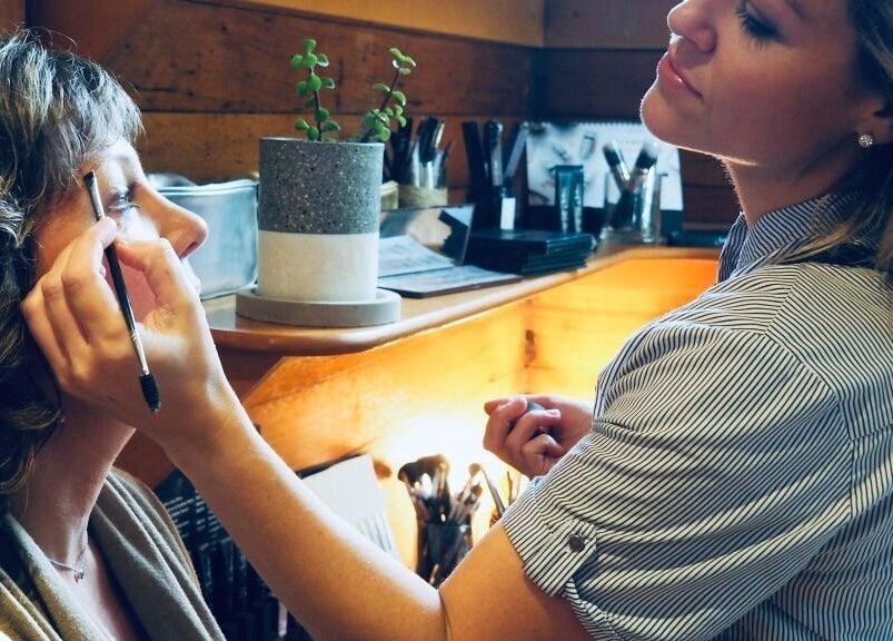Makeup artist at Balanced Beauty in Melbourne, Victoria, AU applying eye makeup to a client.