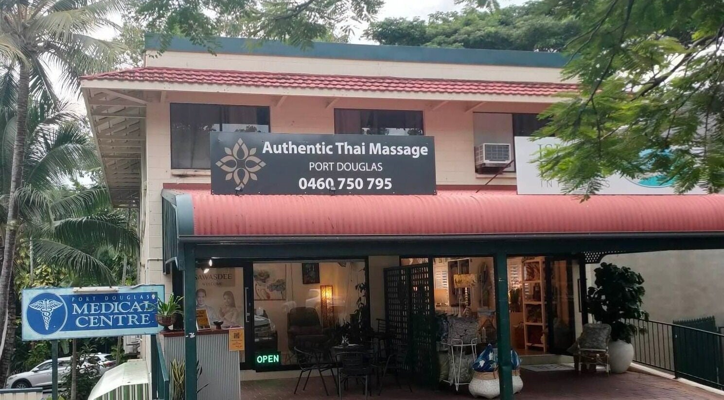 Entrance of Authentic Thai Massage Port Douglas in Port Douglas, Queensland, AU amidst lush greenery.