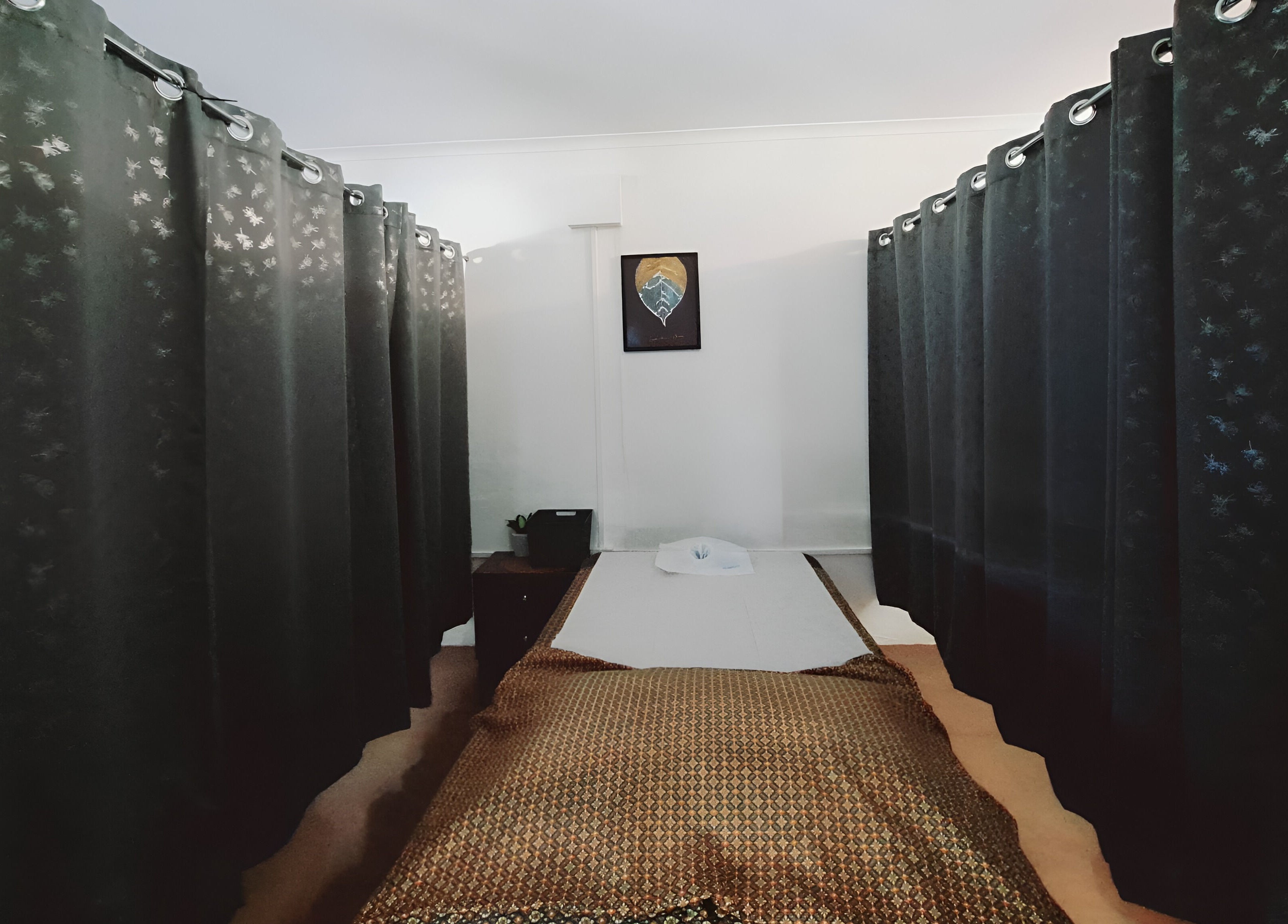 Relaxing massage room at Authentic Thai Massage Port Douglas, Port Douglas, Queensland, AU with dark curtains.