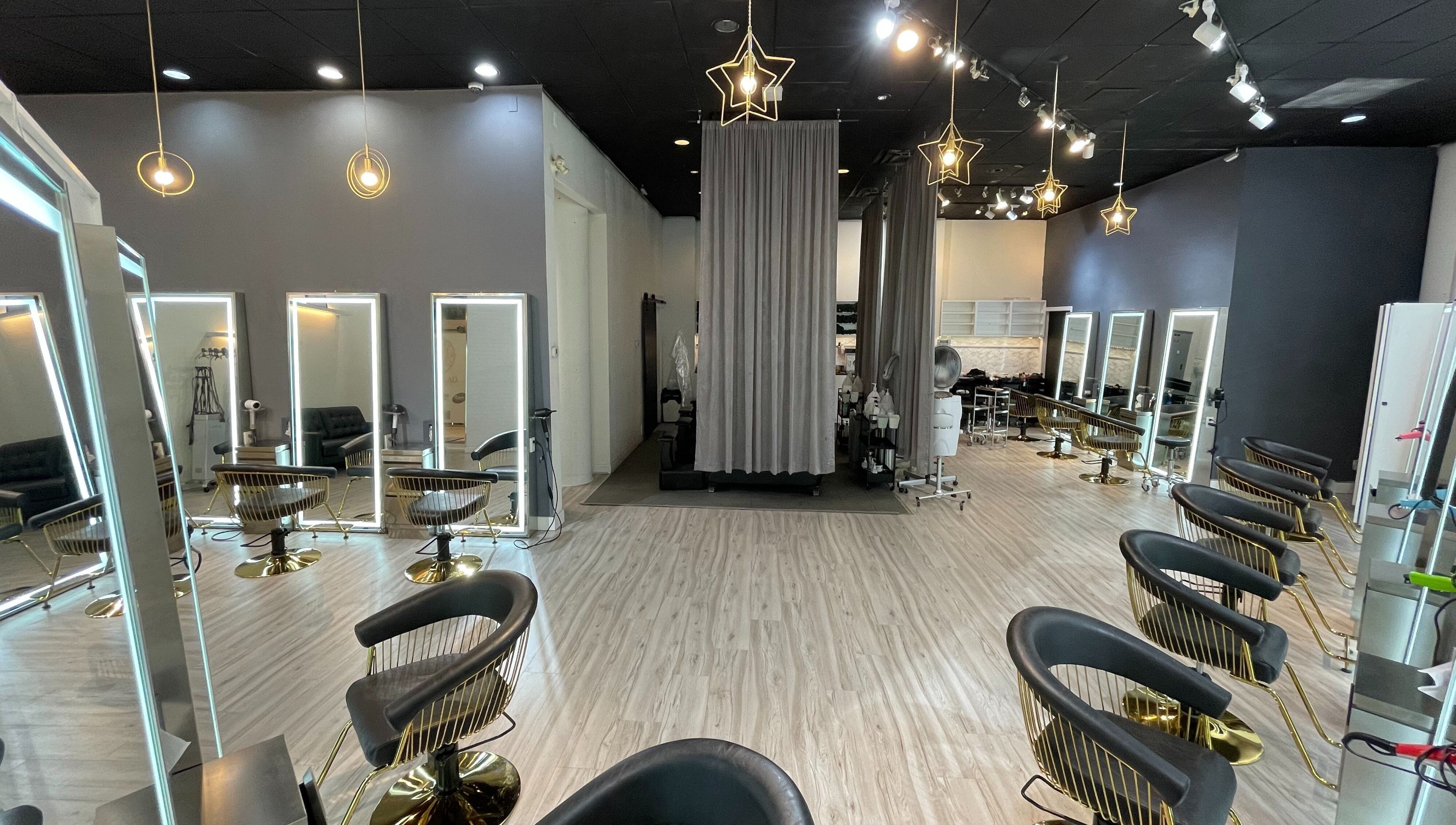 Elegant salon interior of Mophead Aberdeen in Richmond, British Columbia, CA with stylish chairs and star-shaped lights.