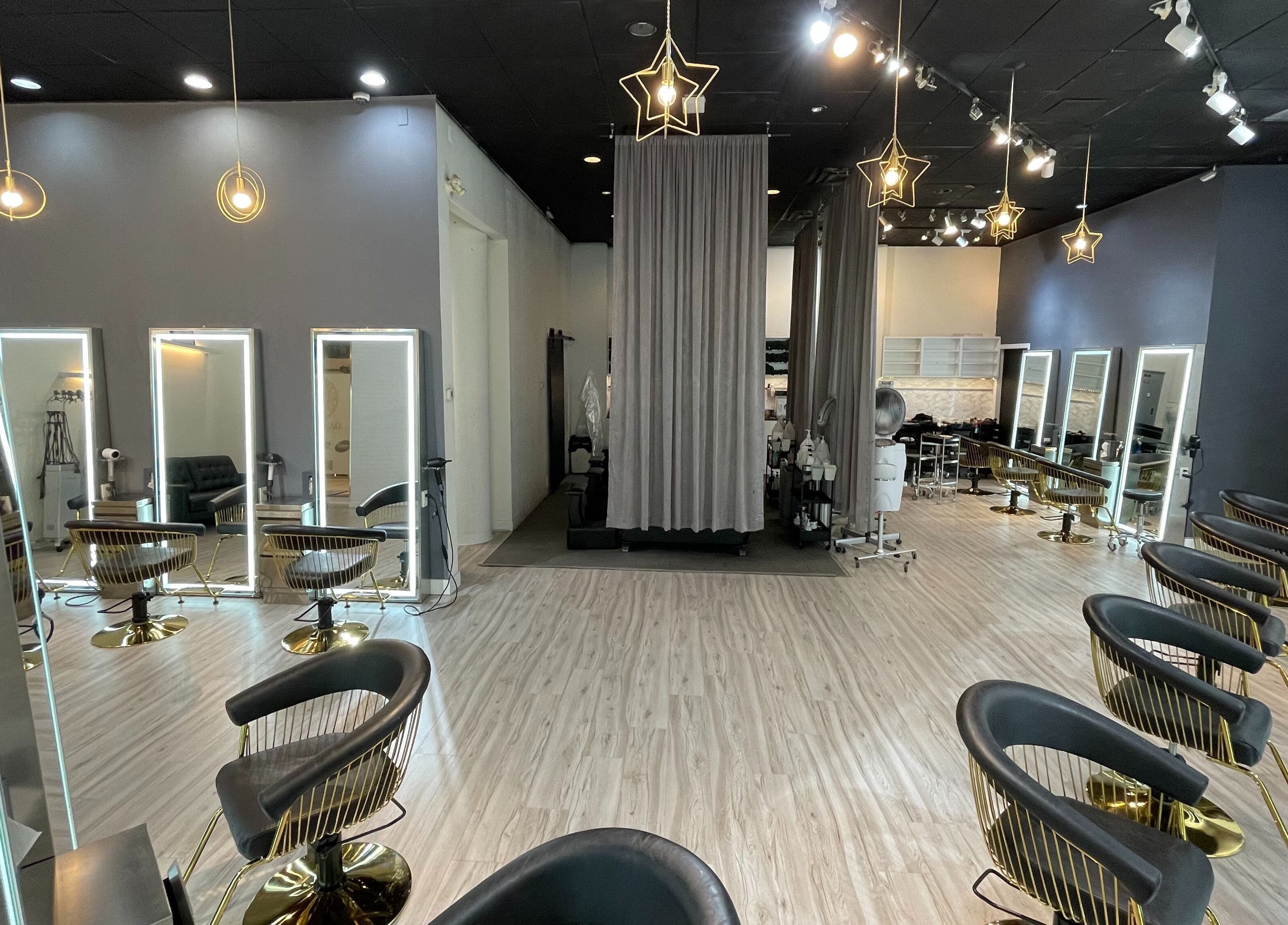 Elegant salon interior of Mophead Aberdeen in Richmond, British Columbia, CA with stylish chairs and star-shaped lights.