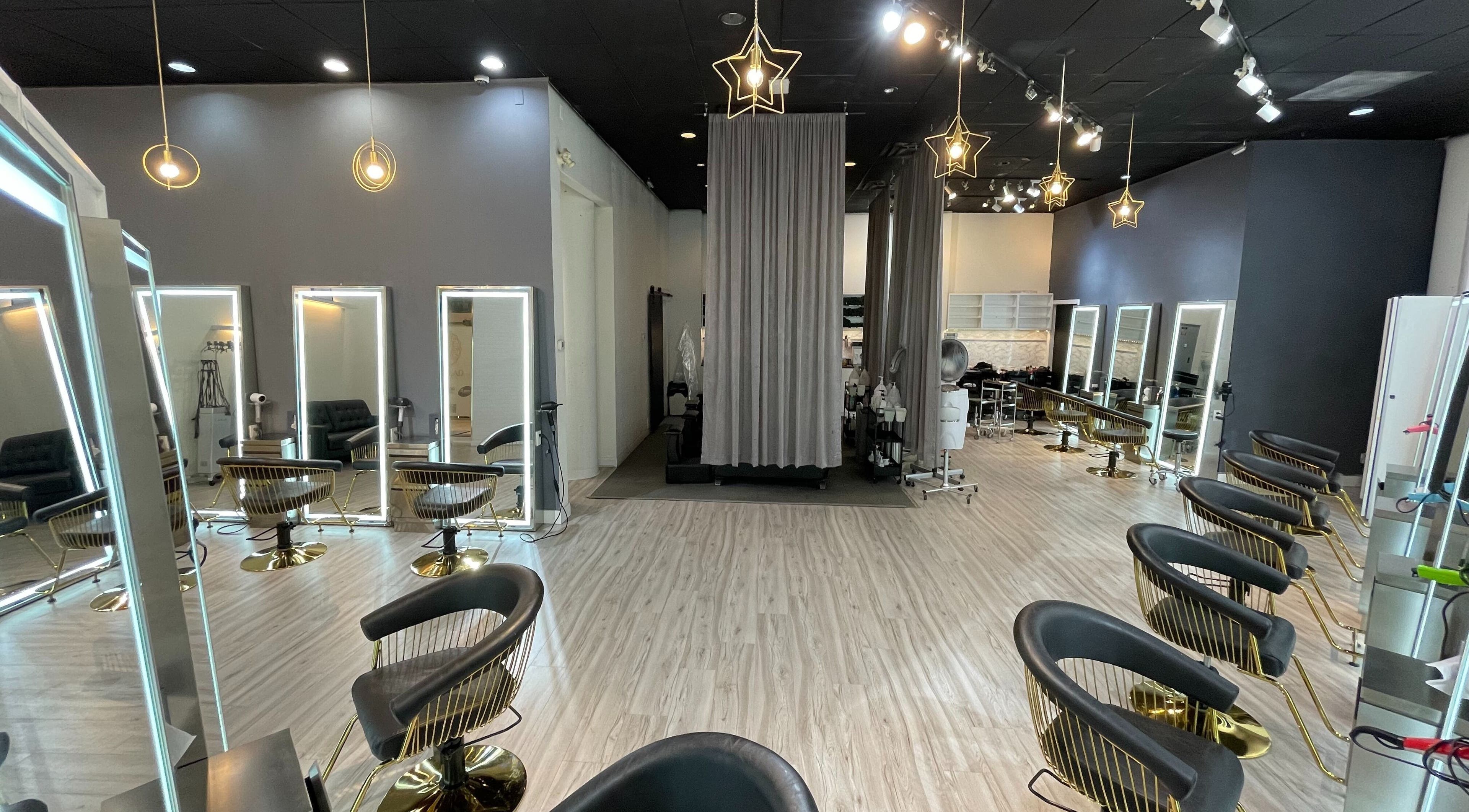 Elegant salon interior of Mophead Aberdeen in Richmond, British Columbia, CA with stylish chairs and star-shaped lights.