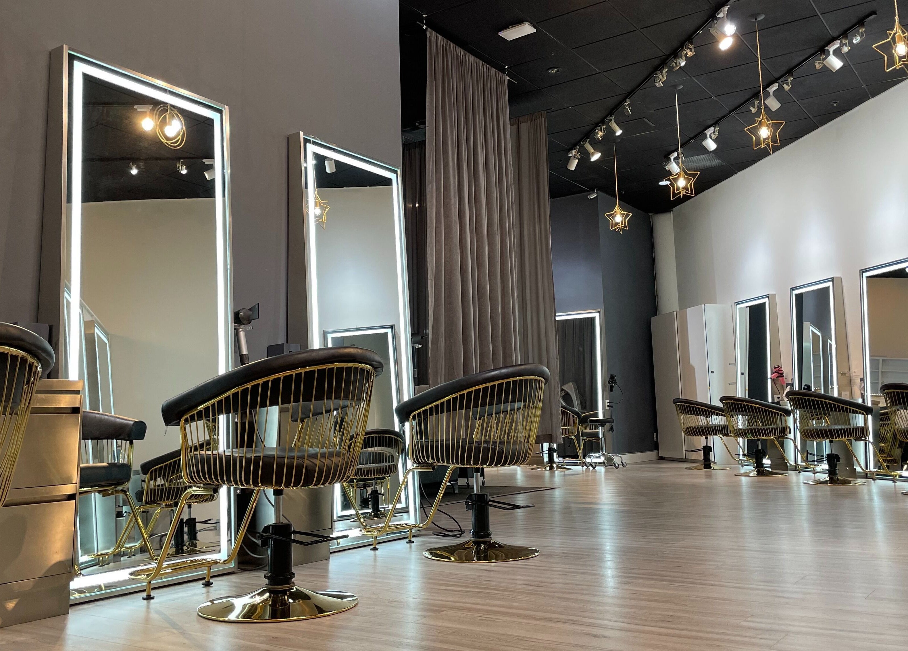 Chic salon interior at Mophead Aberdeen, Richmond, British Columbia, CA with star-shaped lights and modern mirrors.