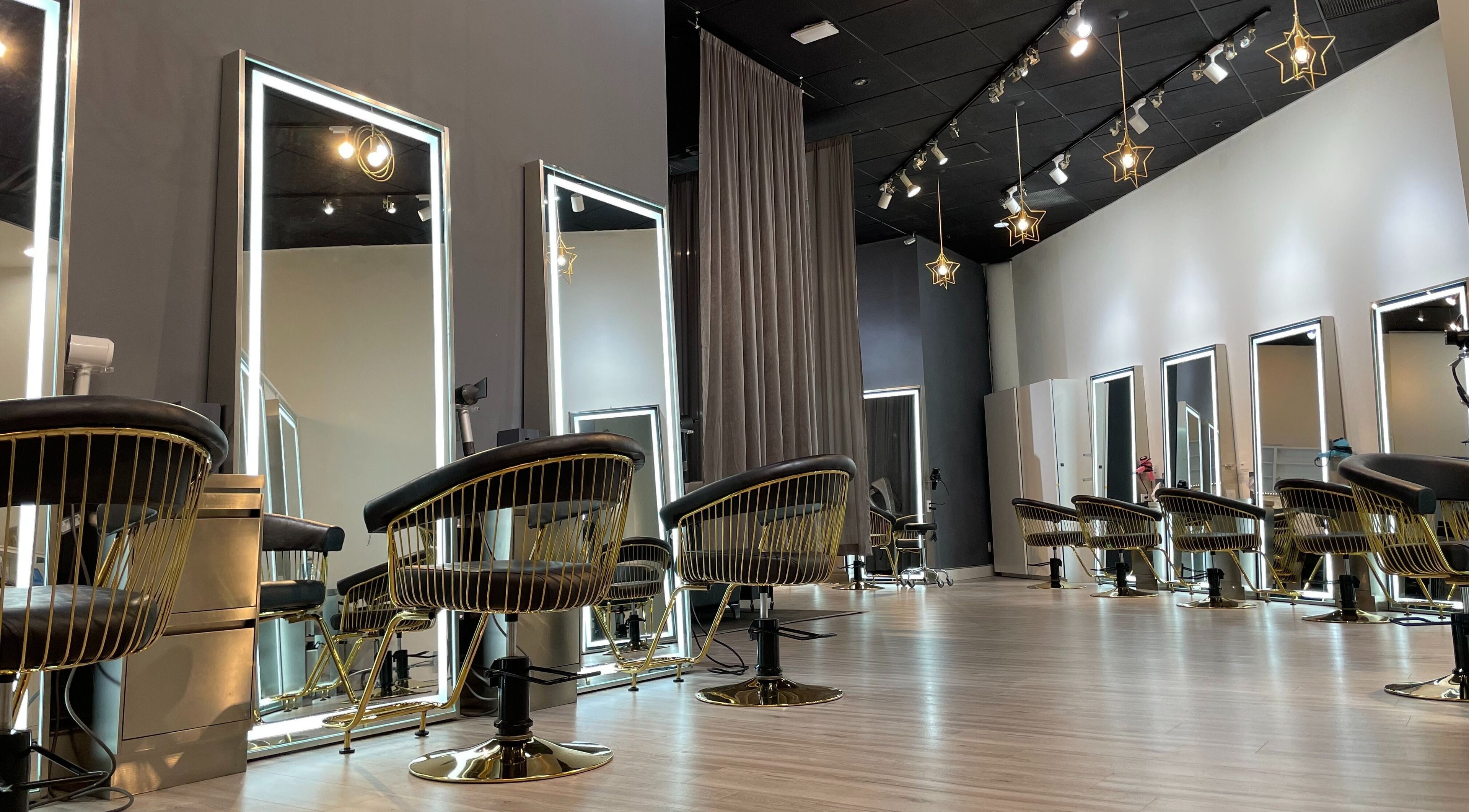 Chic salon interior at Mophead Aberdeen, Richmond, British Columbia, CA with star-shaped lights and modern mirrors.
