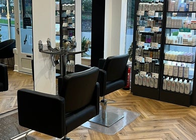 Interior of Andrew David Hair, Lymington, England featuring salon chairs and product shelves.